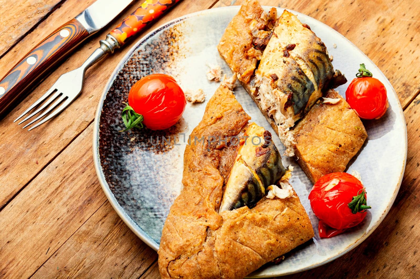 Delicious fish pie with mackerel on on baking paper. Fish baked in bread.