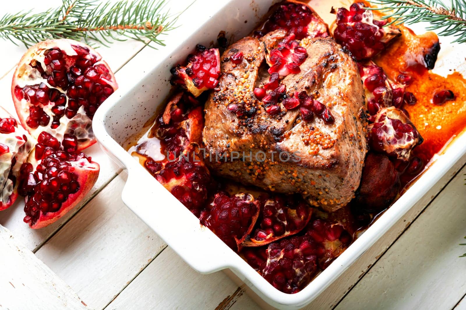 Tasty piece of pork meat baked with pomegranate. Recipes for Christmas.