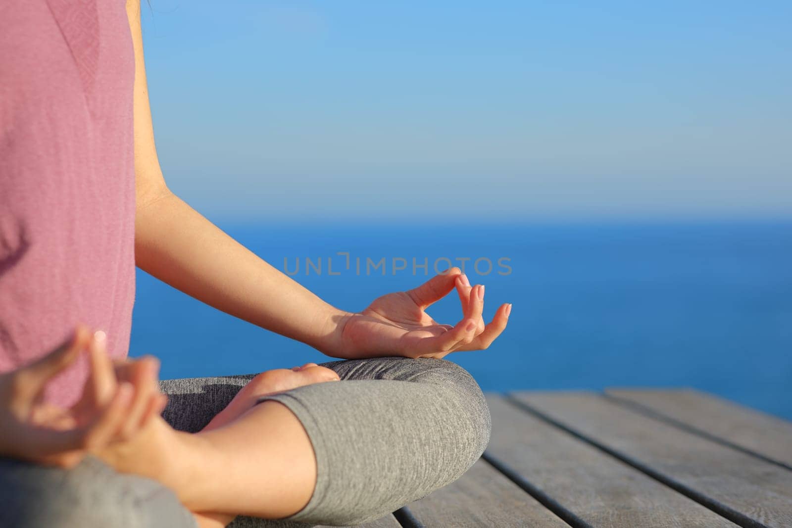 Close up of yogi hands doing yoga exercise on the beach