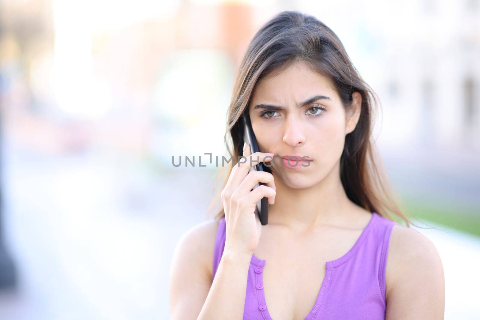 Suspicious woman attending phone call in the street
