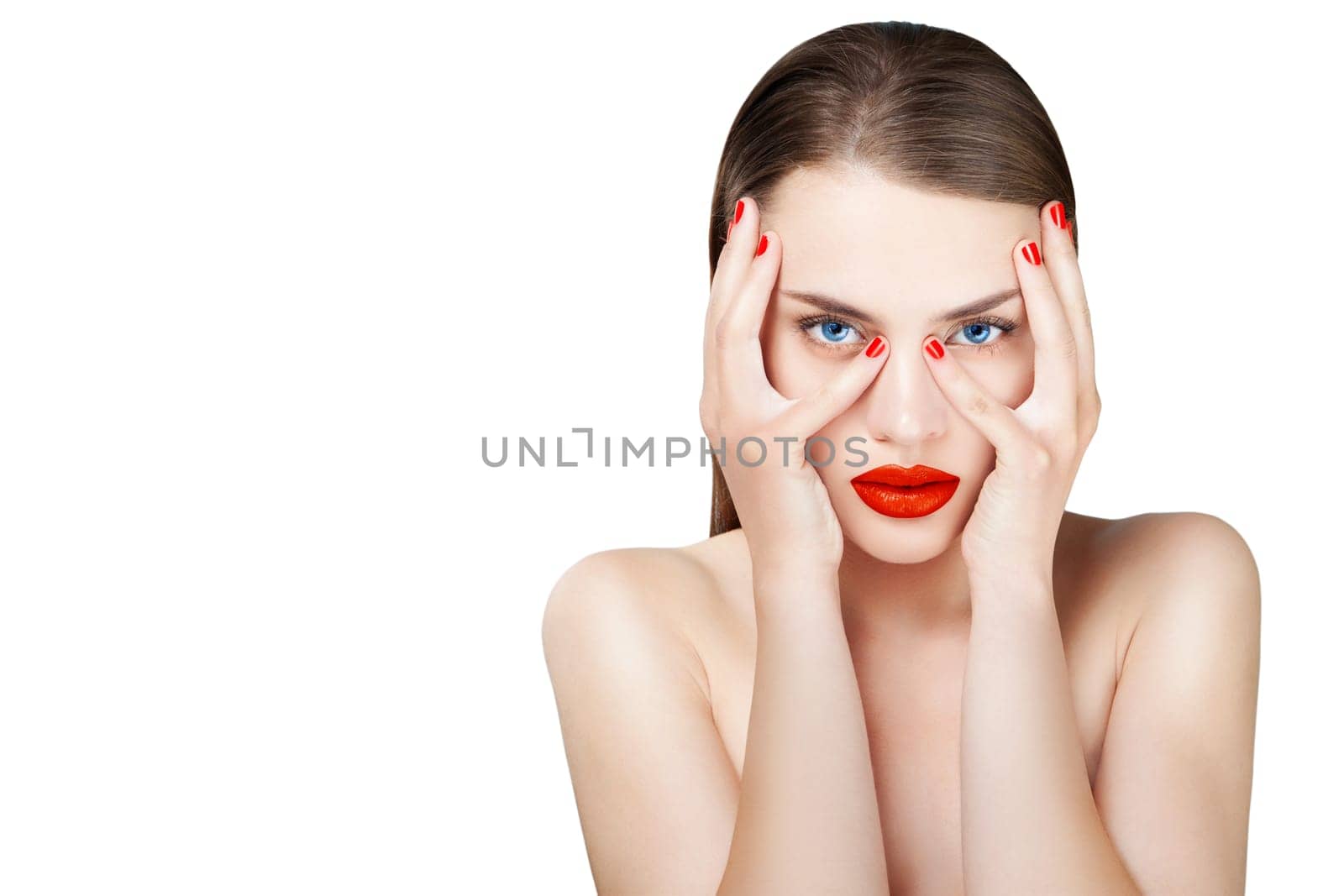 Hot young female model with sexy red lips makeup, strong eyebrows, clean shiny skin, red bright fingernails and blue eyes. Luxury fashion style, manicure, cosmetics and make-up.