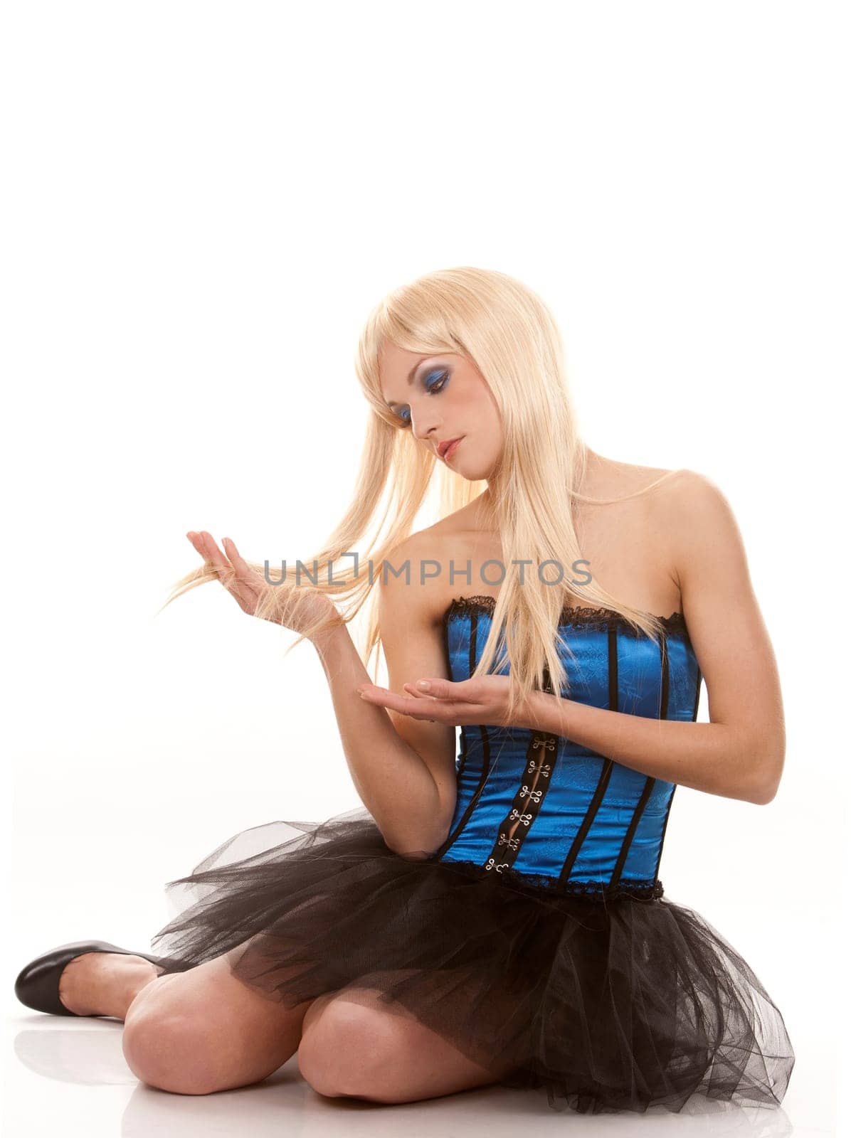 pretty blond woman wearing corset and black skirt on white background