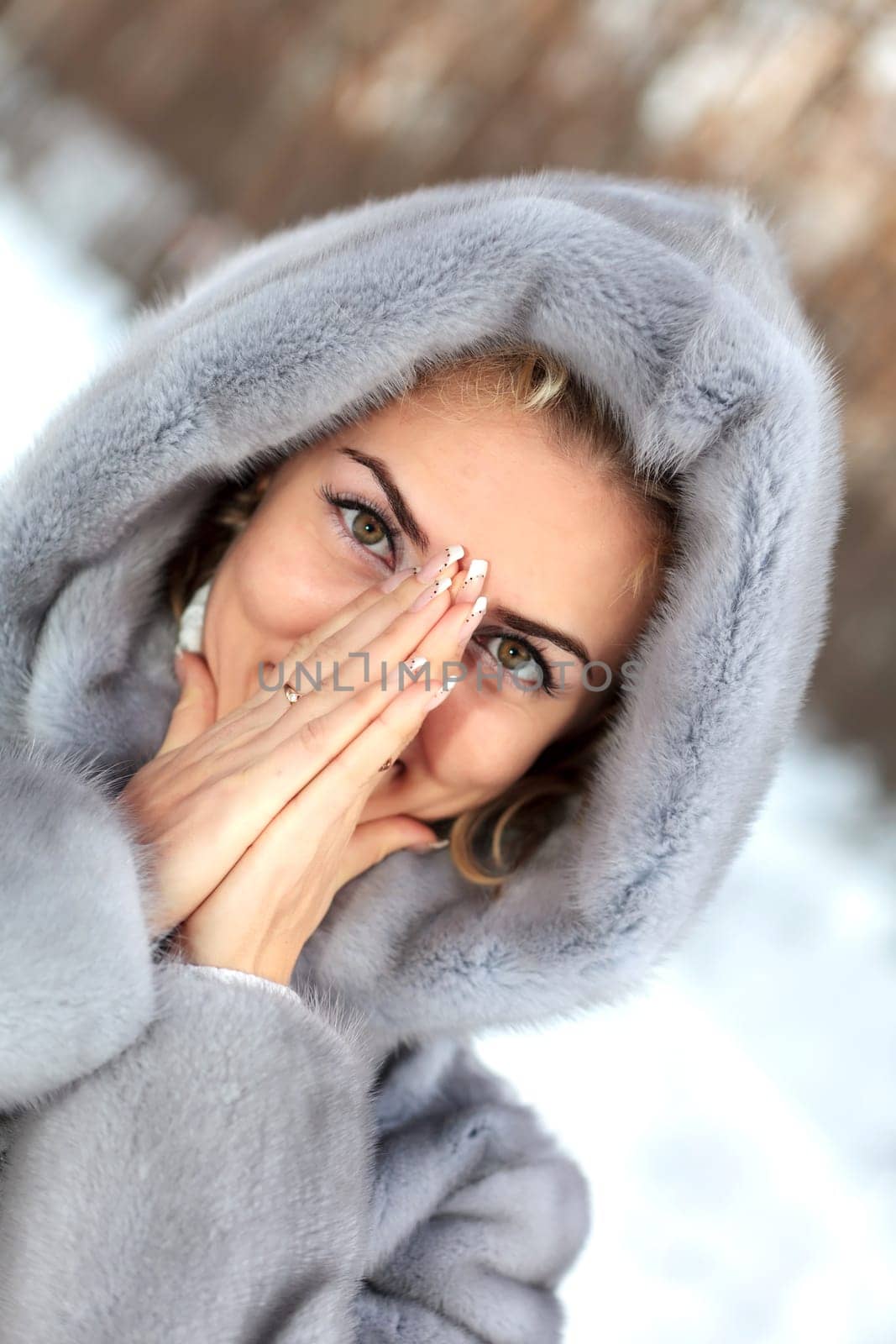 Beautiful young woman in winter clothes outdoor in forest