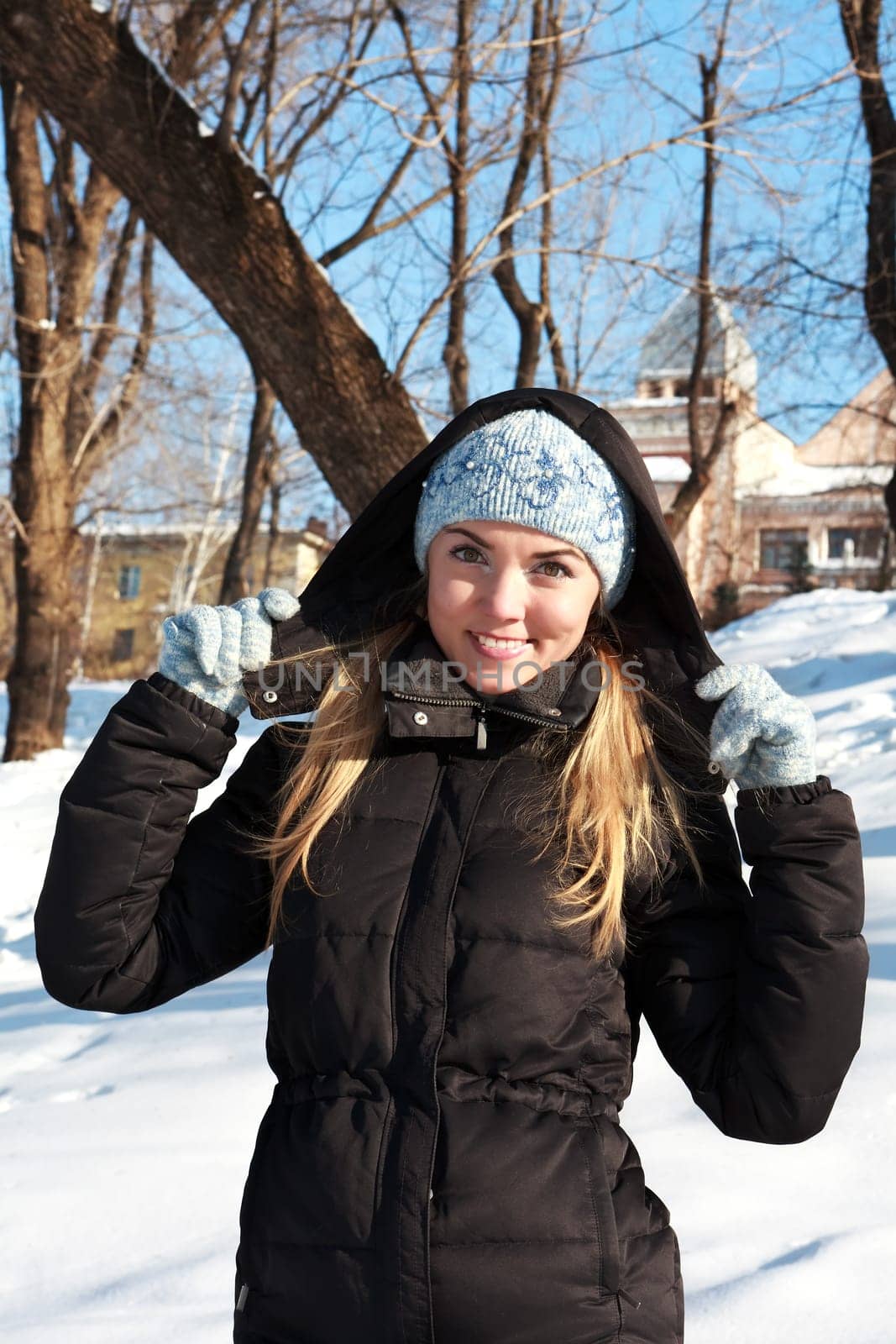 Beautiful young woman in winter clothes outdoor in forest