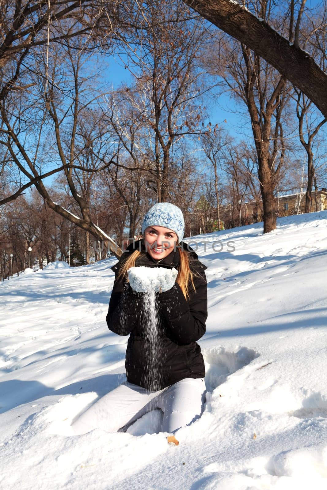 Beautiful young woman in winter clothes outdoor in forest
