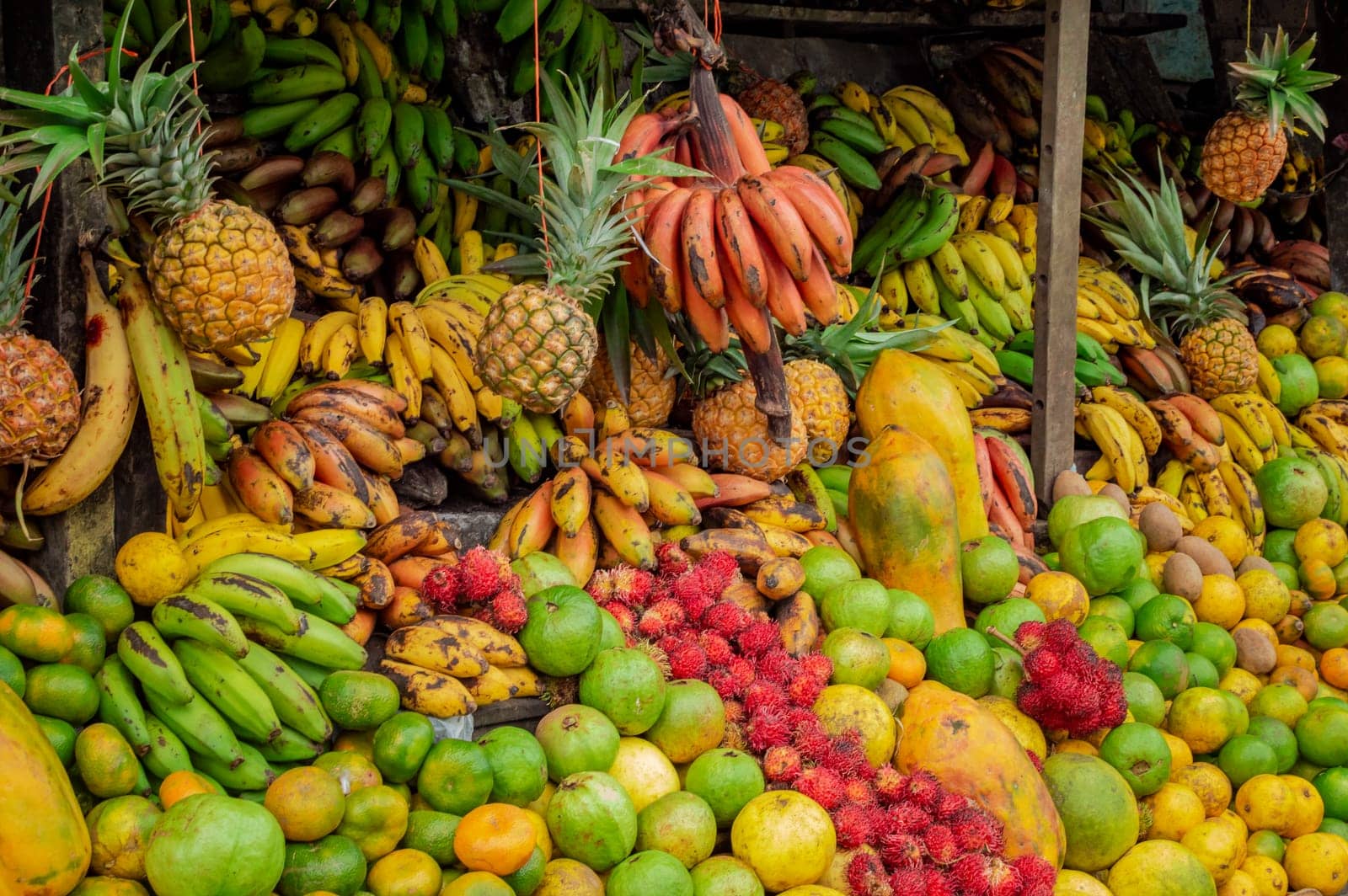 Shelf of many fresh fruits, fresh fruit stall, concept of fruits and healthy food, sale of various fruits