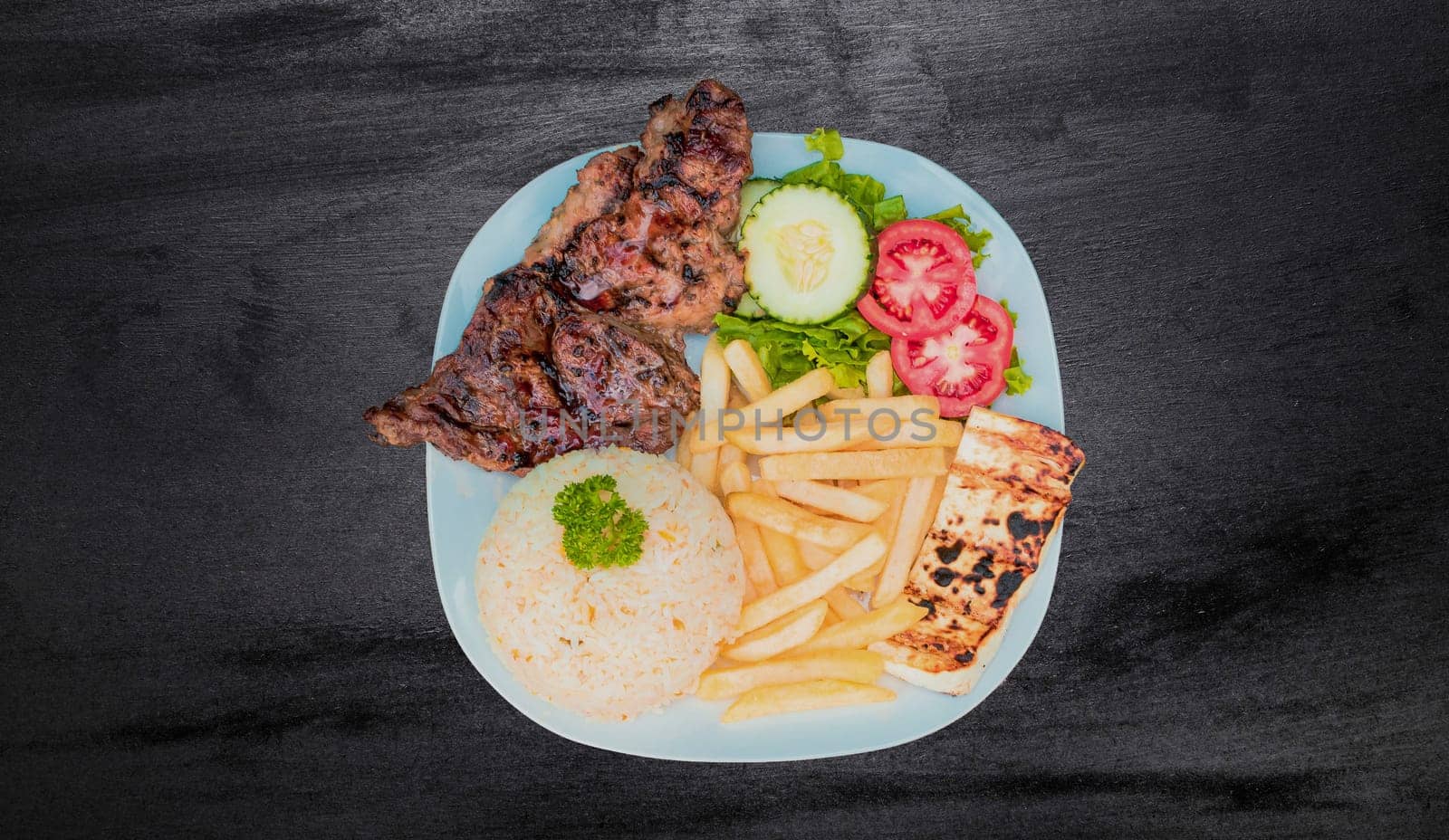 Plate of roasted chicken with rice and french fries on wooden table, Top view of plate of roasted chicken with rice and french fries served, Typical Nicaraguan food roasted chicken with french fries