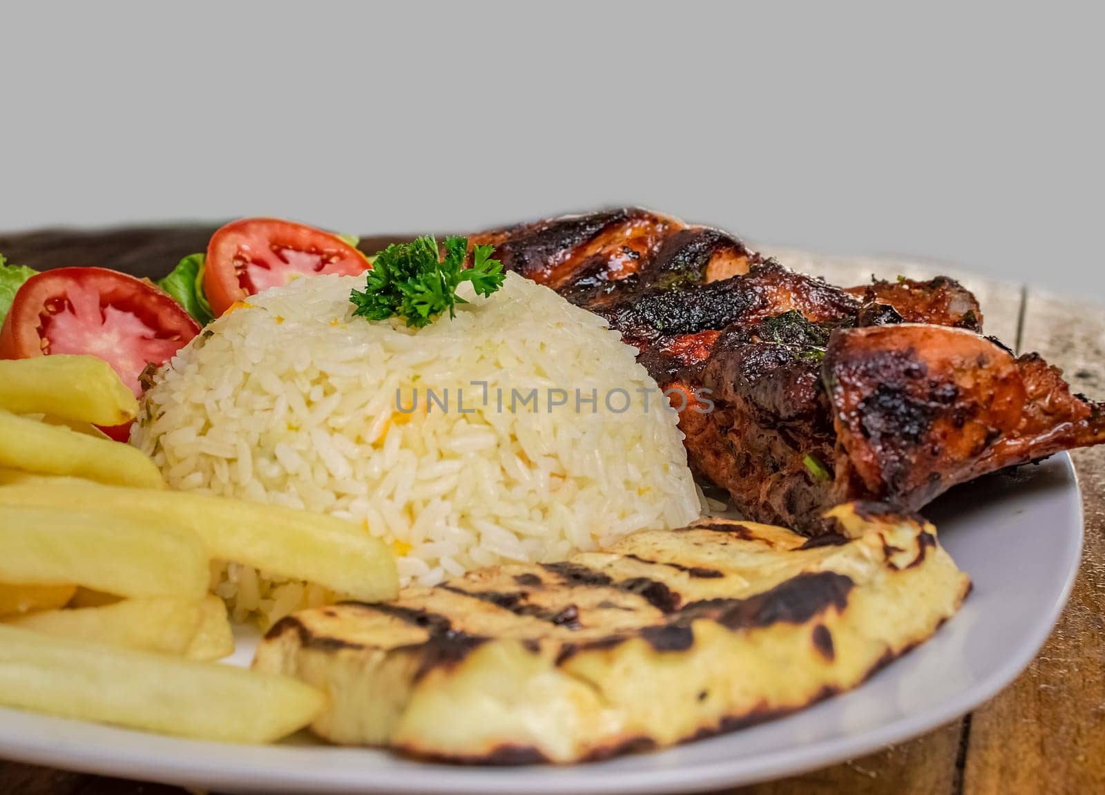 Pork rib with rice, fried cheese and salad served on the table, Close up of Pork rib with salad and French fries served on wooden table, Top view of plate of fresh Pork rib served on the table