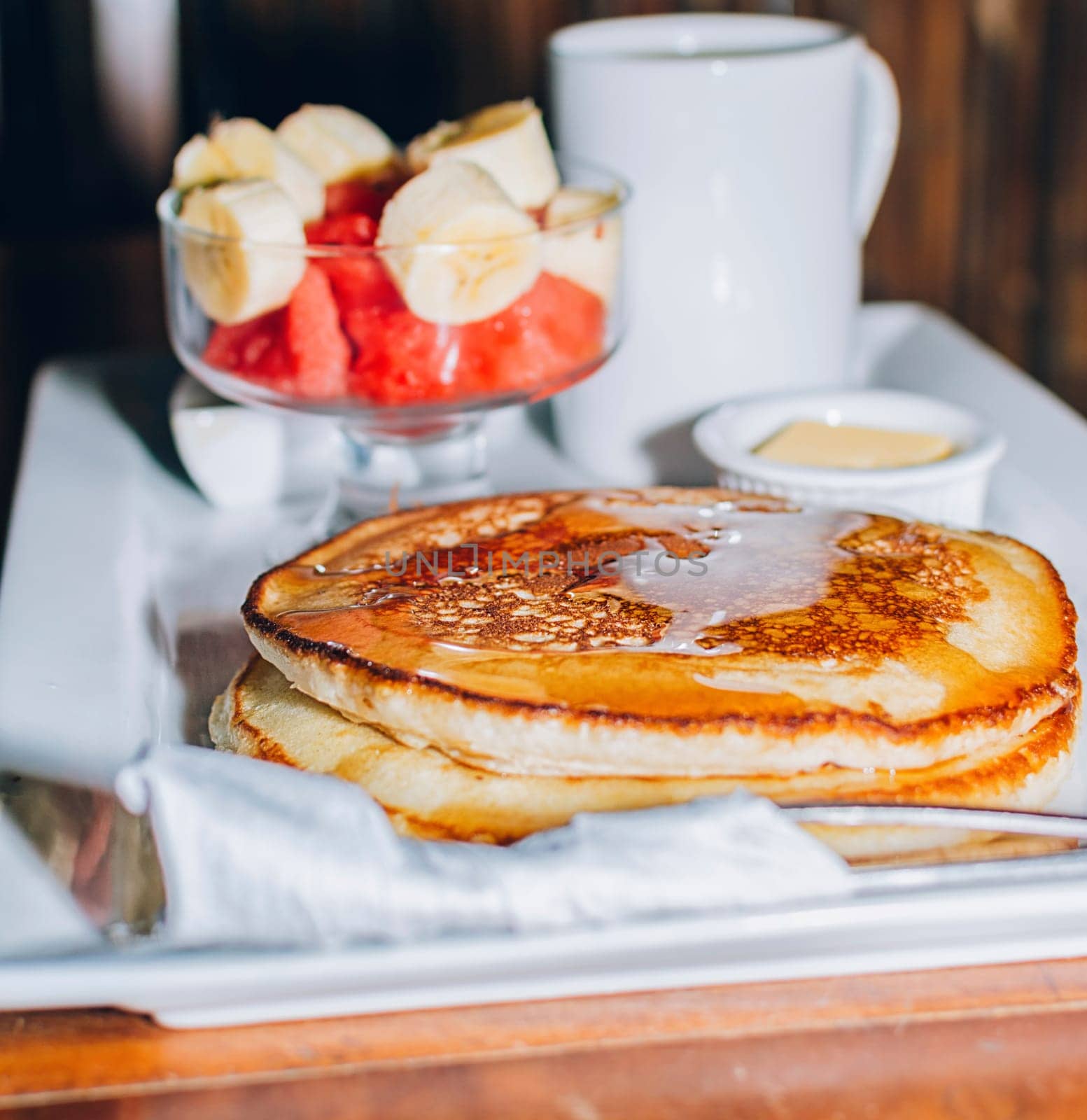 Omelet breakfast with fruit salad served on a wooden table, healthy breakfast concept with COPY SPACE