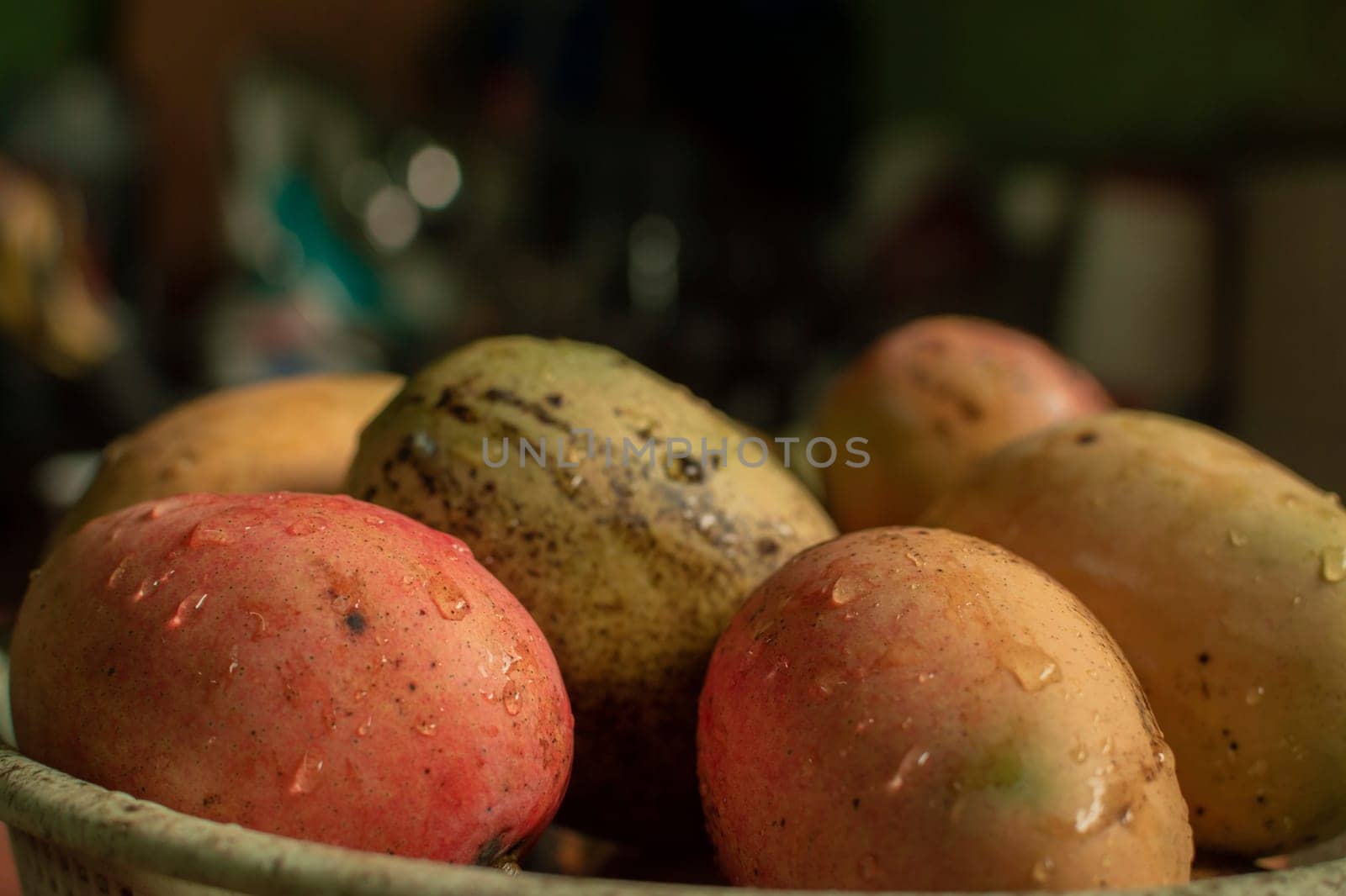 Fresh washed mangoes put in a bowl in the kitchen, Fresh freshly washed mangoes on bowl with copy space, concept of fresh mangoes in a basket