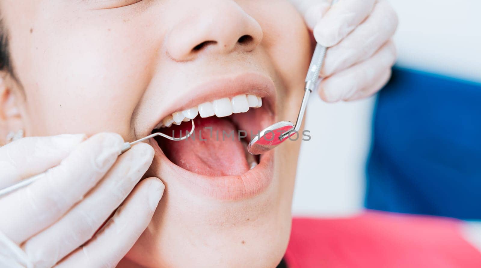 Hands of a specialist dentist cleaning the teeth of a female patient. Close up of dentist hands cleaning patient. Close-up of the hands of a dentist cleaning the teeth of a female patient
