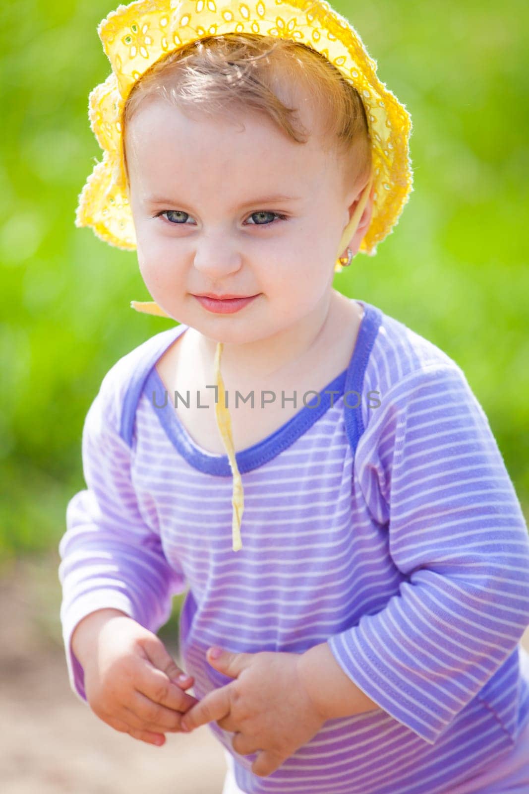 Portrait of 1 year old baby girl enjoying a day on a meadow.