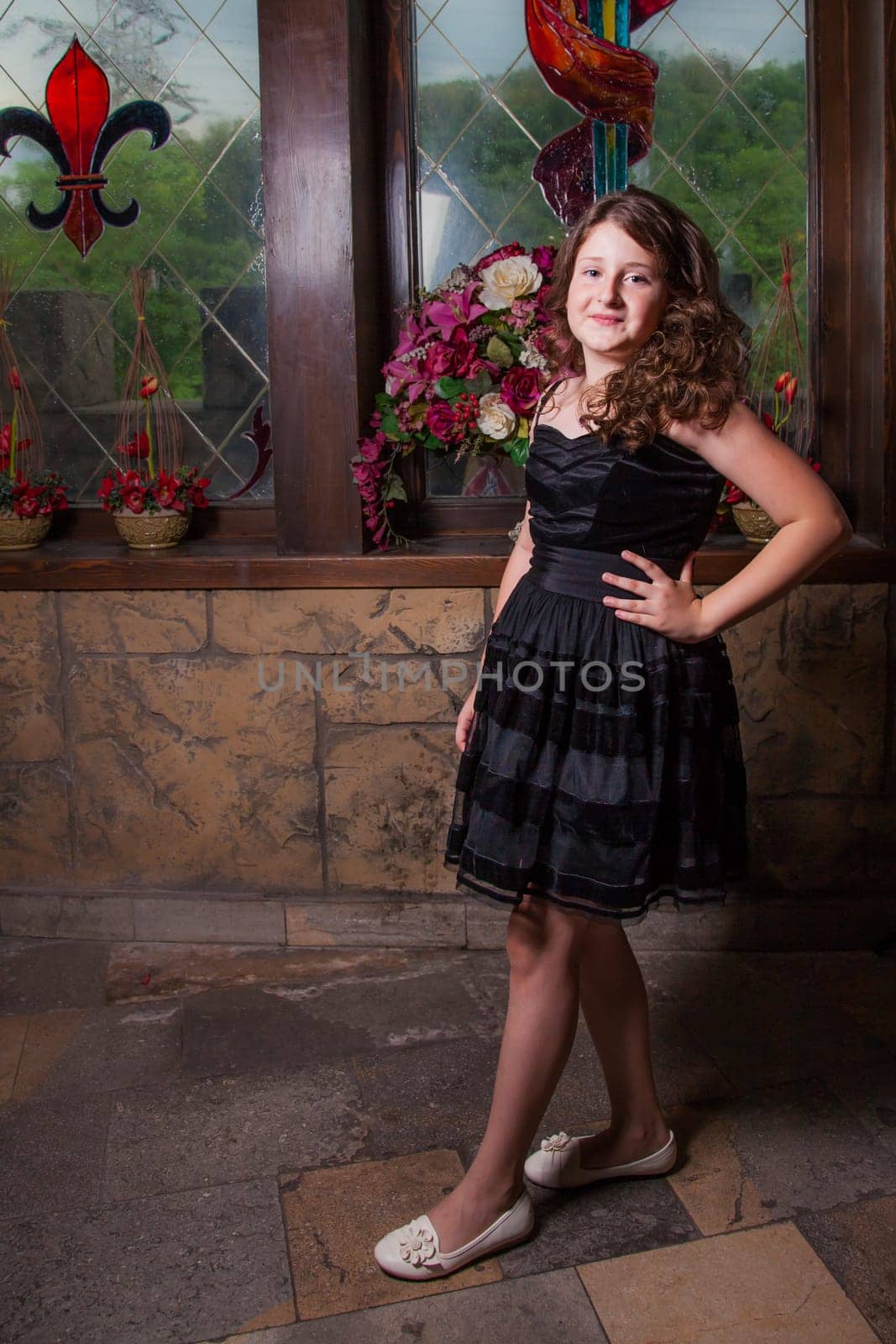 Portrait of a 10 year old girl posing in a castle.