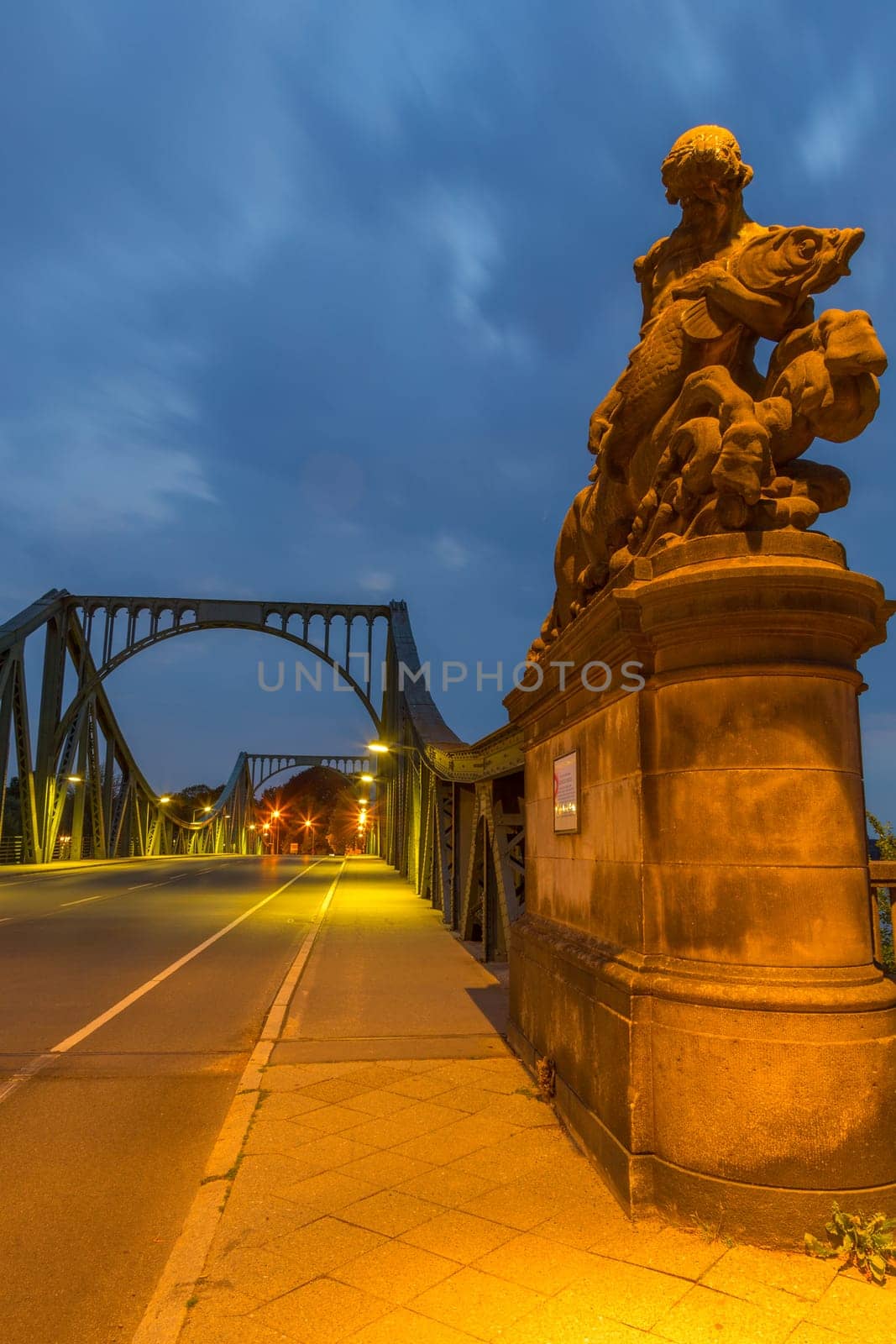 Male statue with fish at the beginning of the Glienicker Bridge