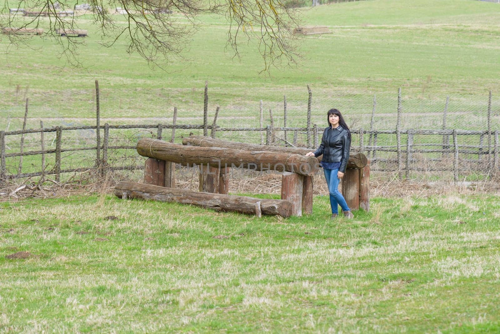A girl is playing on a wood artefact