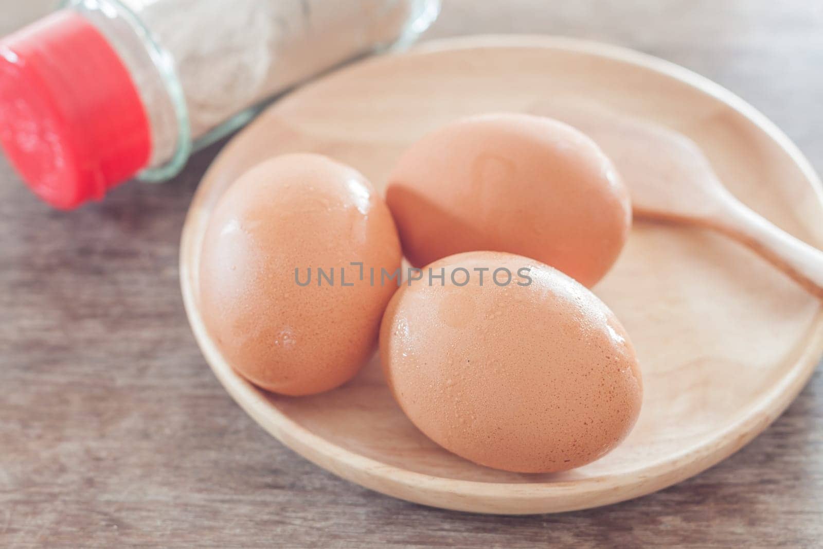 Fresh eggs on wooden plate, stock photo
