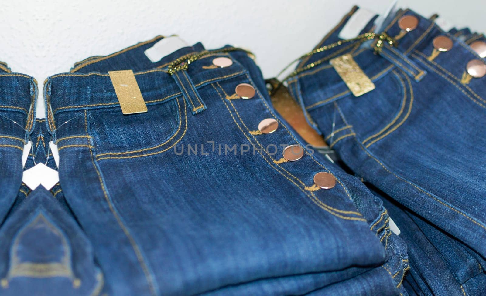 Close up of blue jeans over others, clothing sale concept, jeans sale concept
