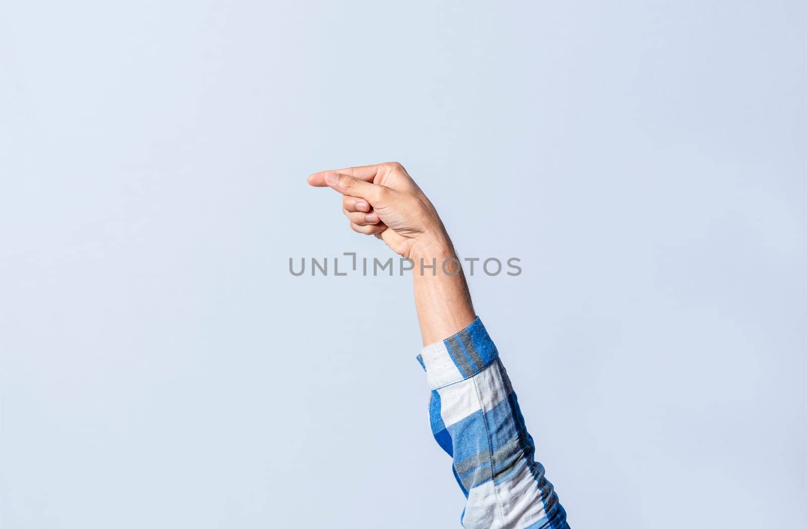 Hand gesturing the letter G in sign language on an isolated background. Man's hand gesturing the letter G of the alphabet isolated. Letters of the alphabet in sign language