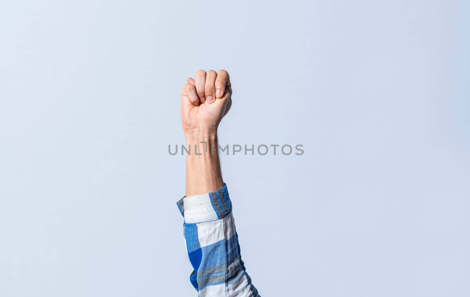Hand gesturing the letter M in sign language on an isolated background. Man's hand gesturing the letter M of the alphabet isolated. Letter M of the alphabet in sign language