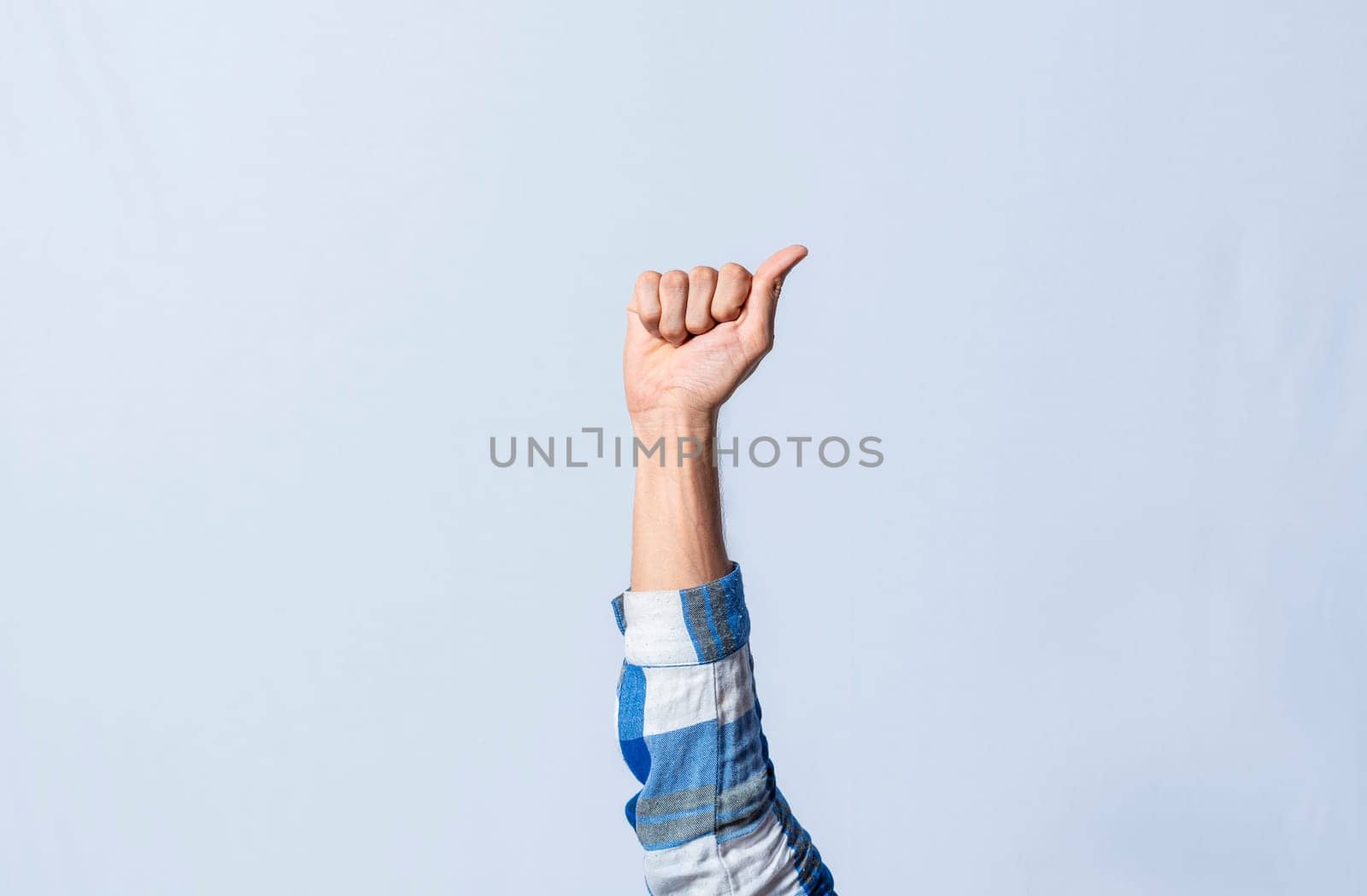 Hand gesturing the letter A in sign language on isolated background. Man hand gesturing the letter A of the alphabet isolated. Letters of the alphabet in sign language.