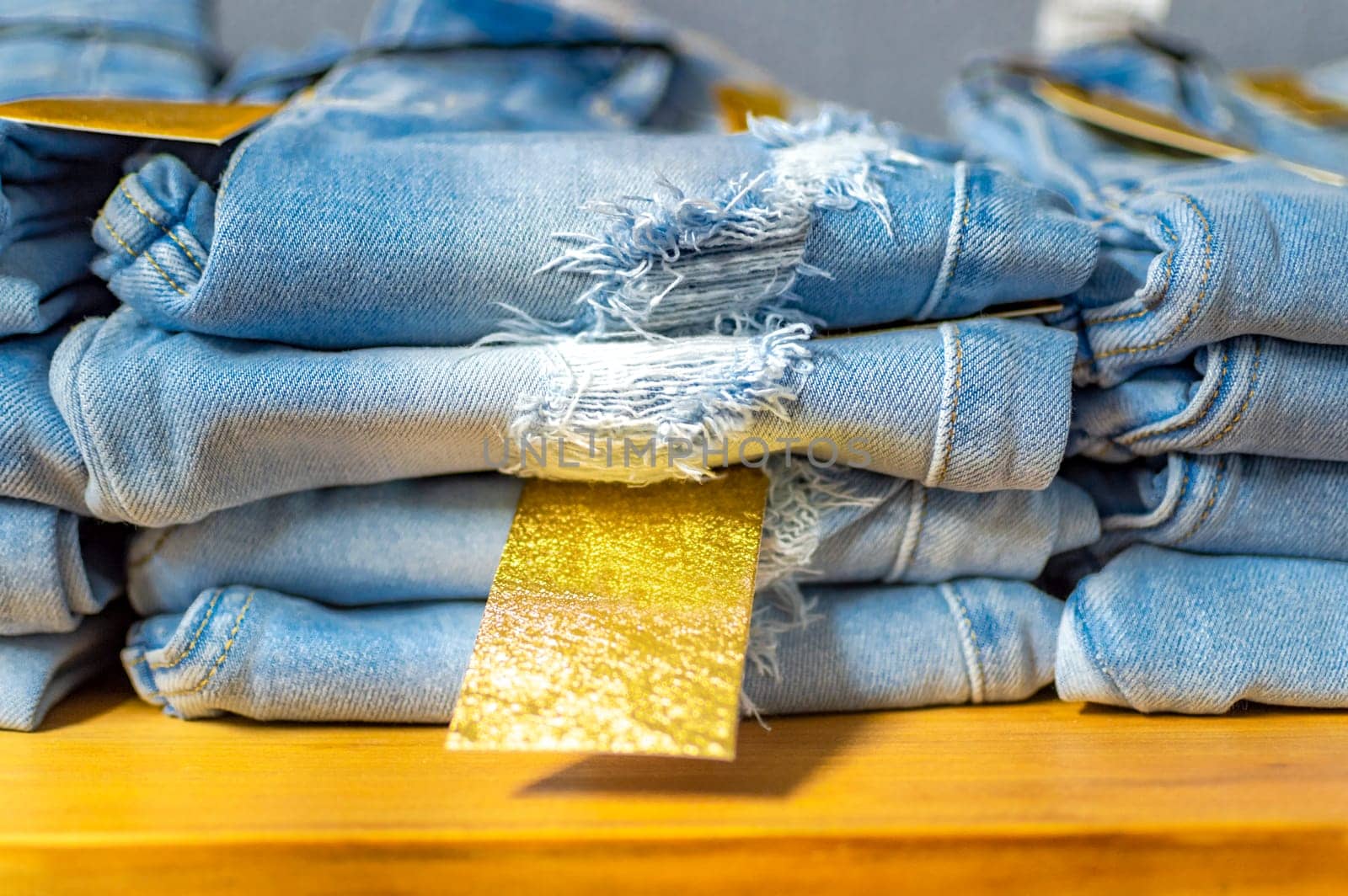 Close up of blue jeans on others with copy space  Various jeans on others with space for text