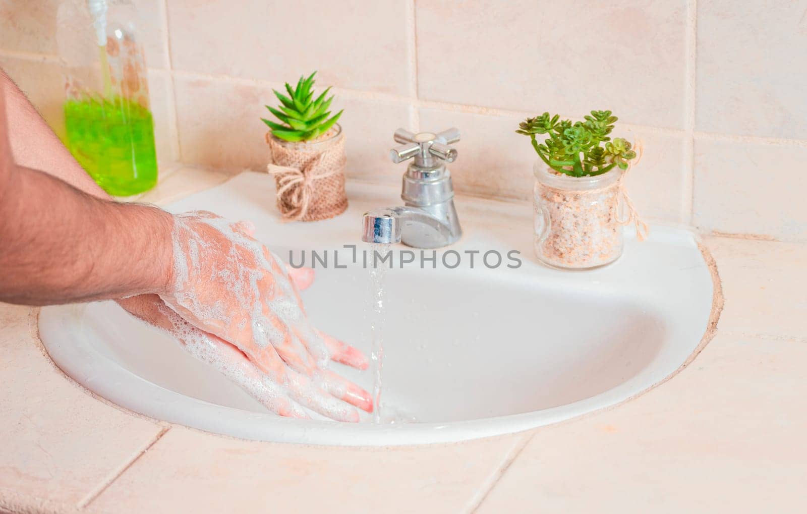 Close up of a person washing their hands with soap, concept of correct hand washing, ways to prevent covid19