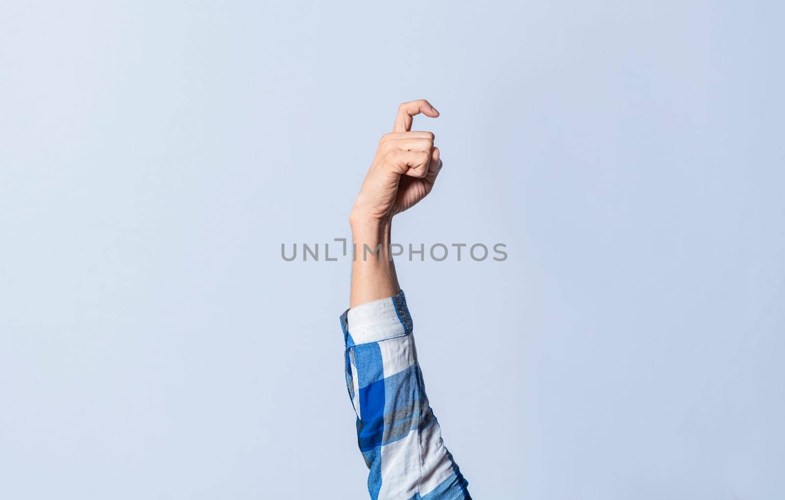 Hand gesturing the letter X in sign language on an isolated background. Man's hand gesturing the letter X of the alphabet isolated. Letter X of the alphabet in sign language