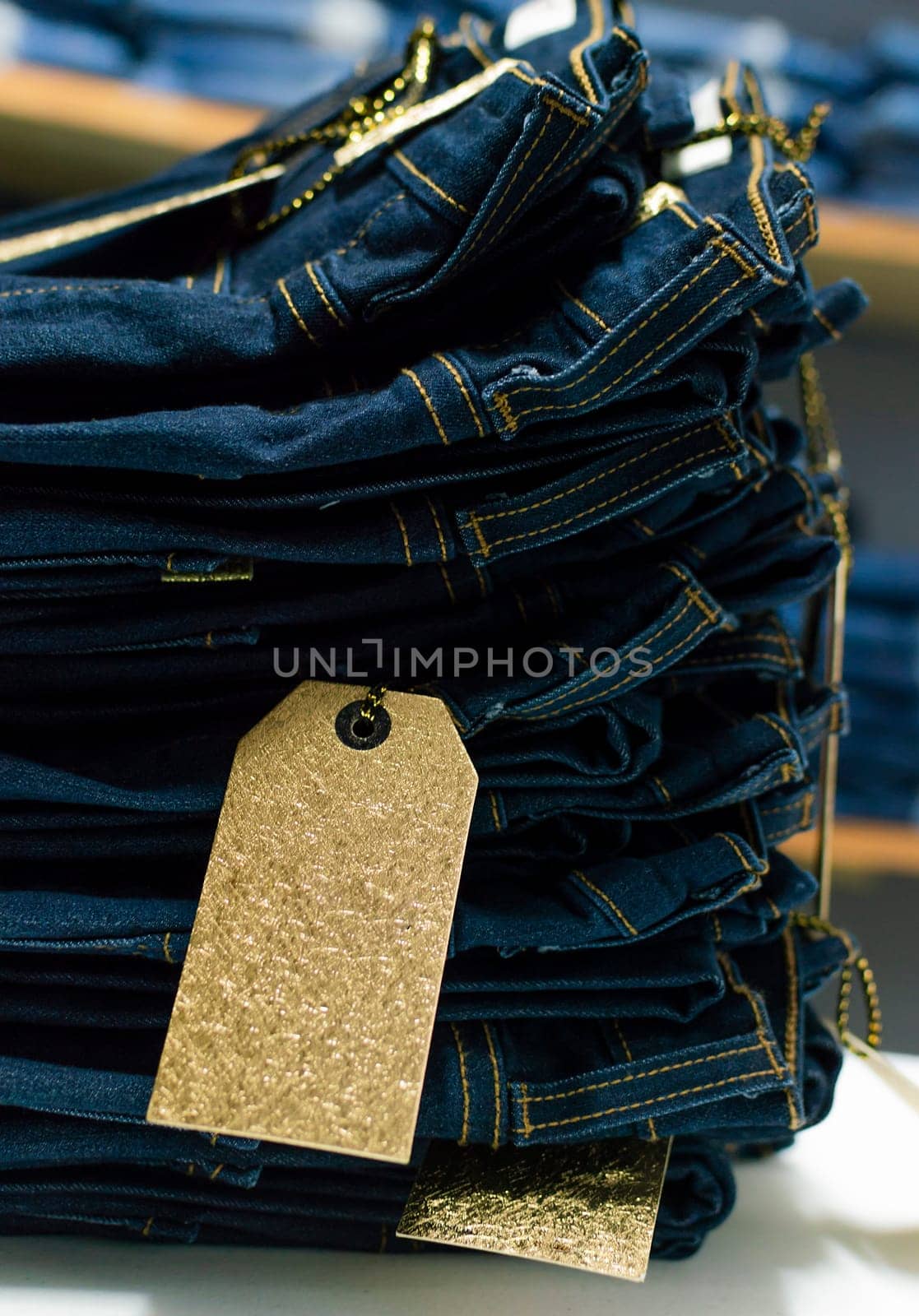 Close up of blue jeans on others with copy space, Various jeans on others with space for text, Clothes sale concept