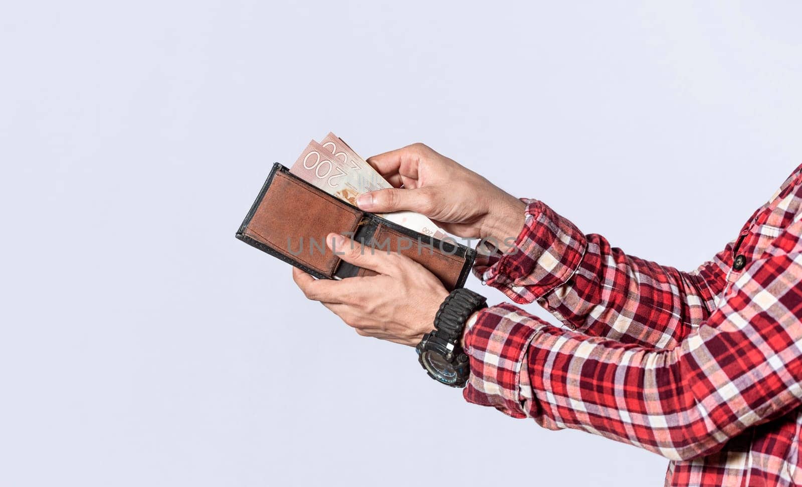 Man taking money out of his wallet, close up of hands taking money out of his wallet isolated, Nicaraguan banknotes, cash payment concept