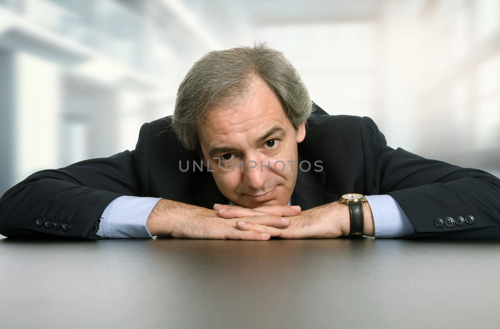 mature business man on a desk, at the office