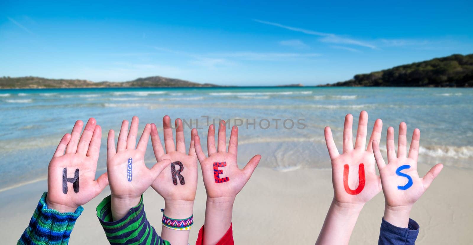 Children Hands Building Colorful English Word Hire Us. Summer Ocean, Sea And Beach As Background.