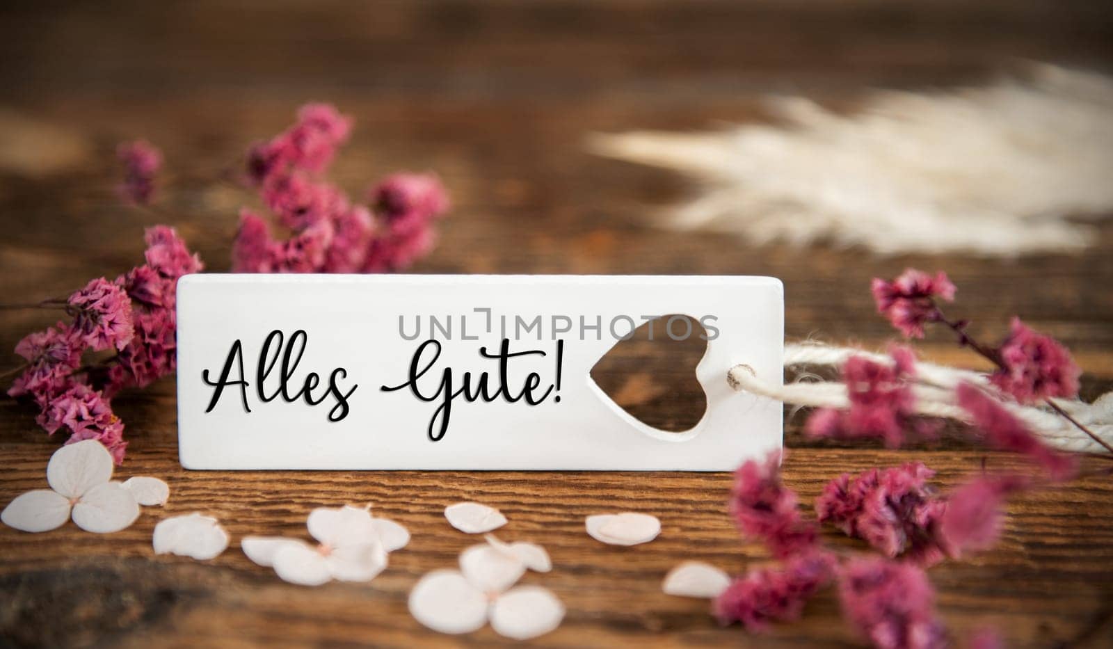 Natural Background With Purple Blossoms and Label With the German Word Alles Gute, Whish Means Best Wishes in English, Summer or Autumn Decoration