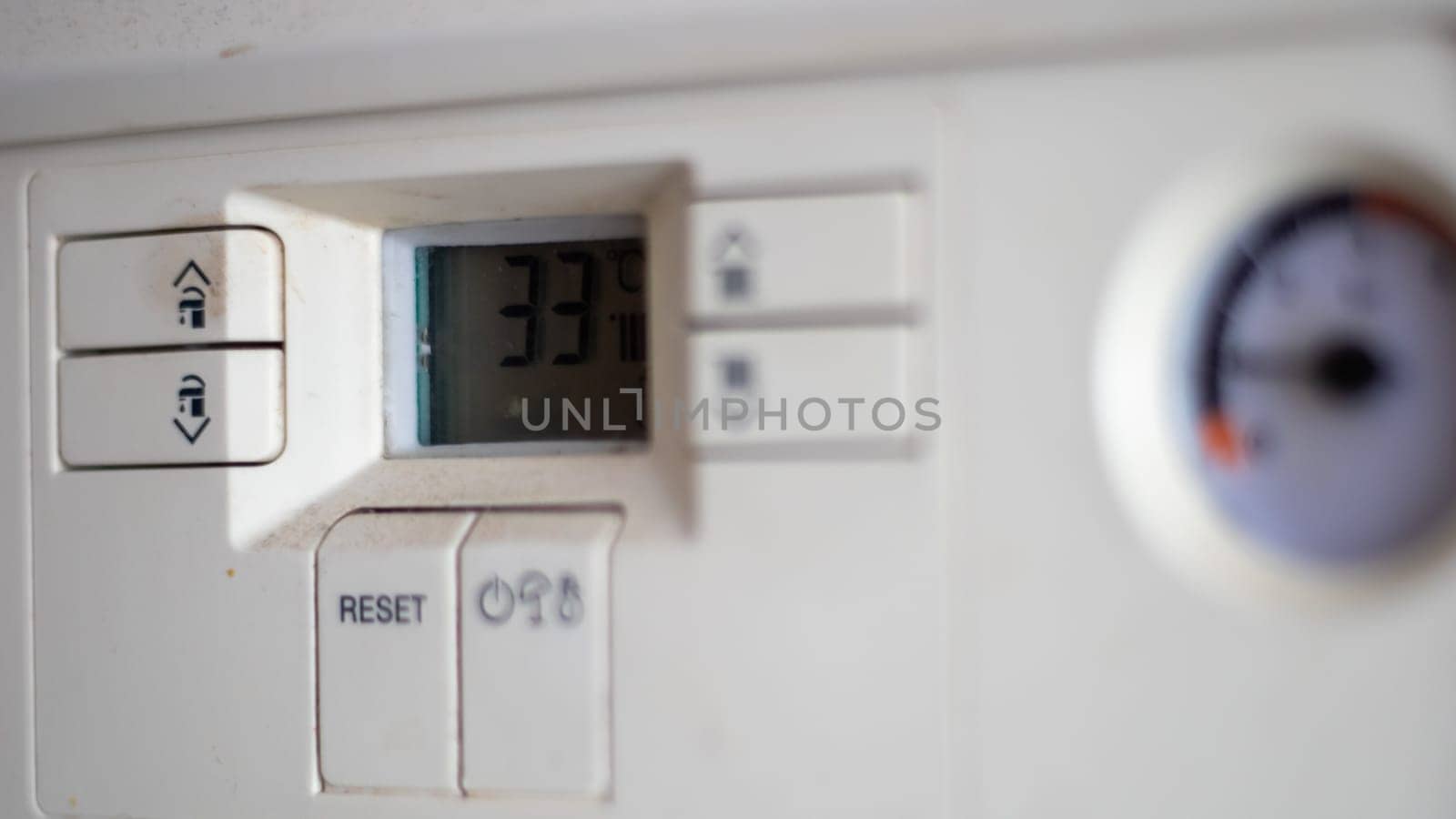 Gas pressure meter on the panel of the heating gas boiler. Symbolic image of the heating season at home. Dial and pressure gauge on combi boiler. Hot water and heating. Boiler accessories