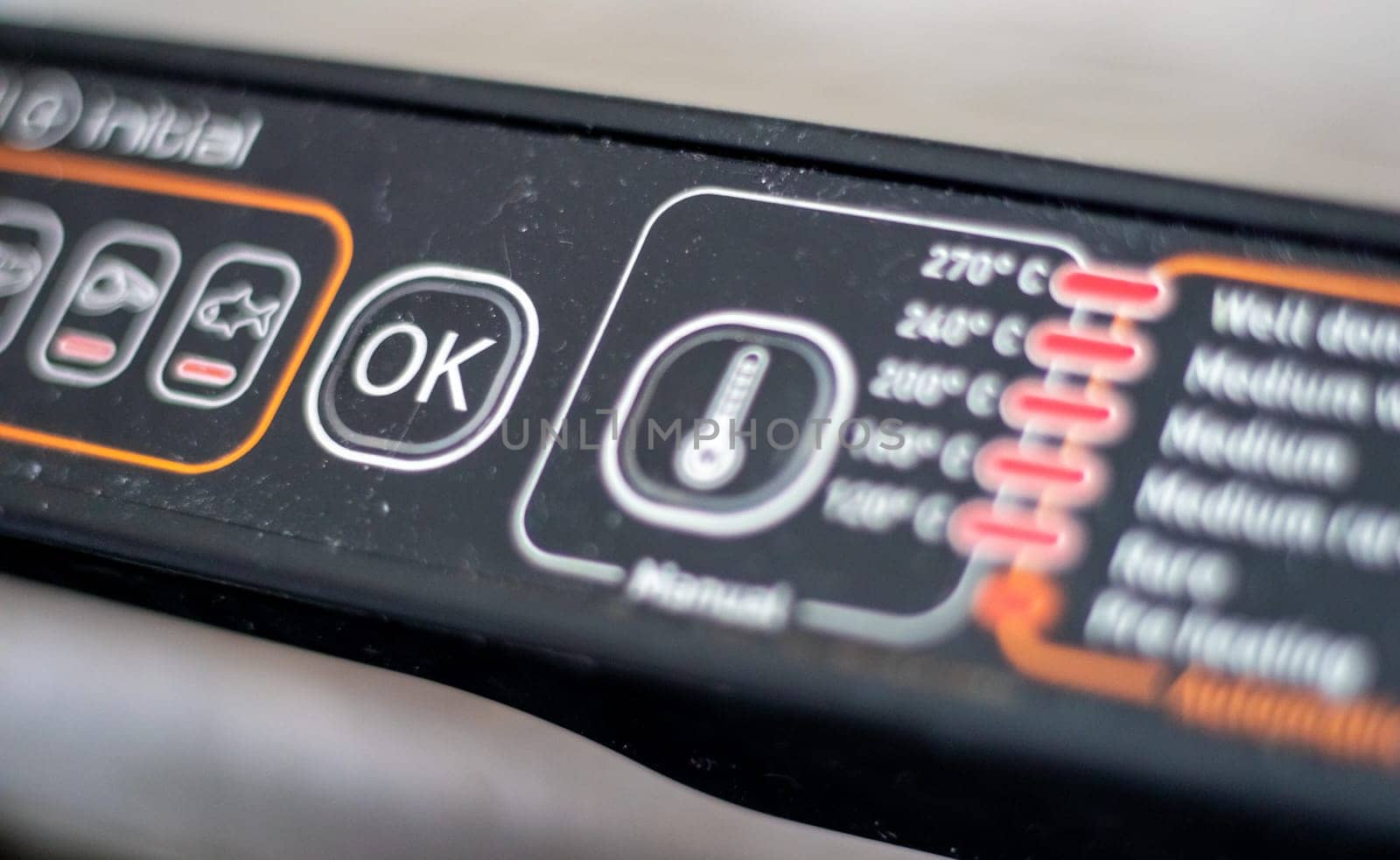 Electric grill power adjustment indicators and power button. The degree of doneness of the steak. Contact grill. Cooking in the home kitchen