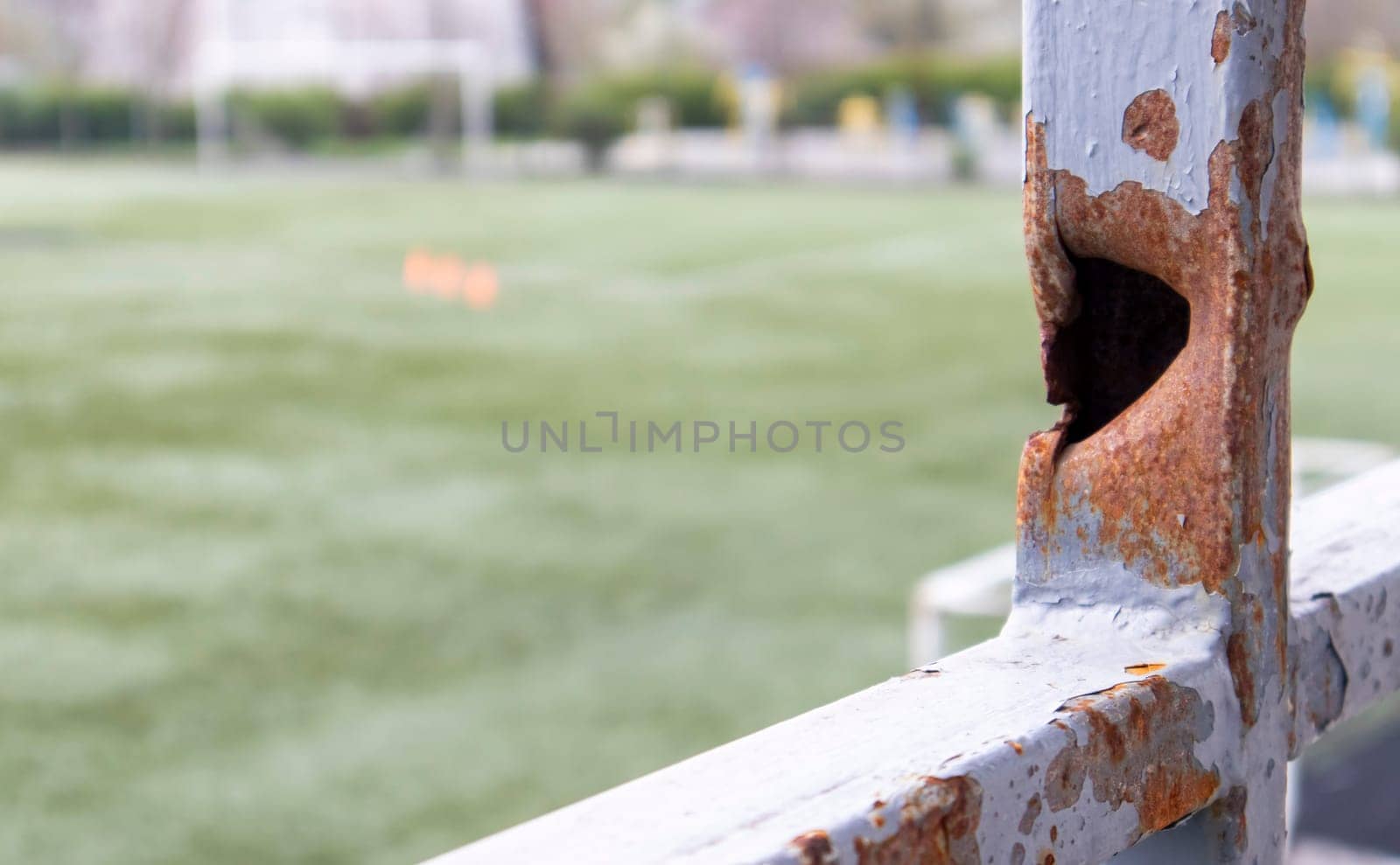 Bullet hole in the pipe. War in Ukraine. A hole from a shell fragment. Consequences of the war. Holes from shots on a metal pipe