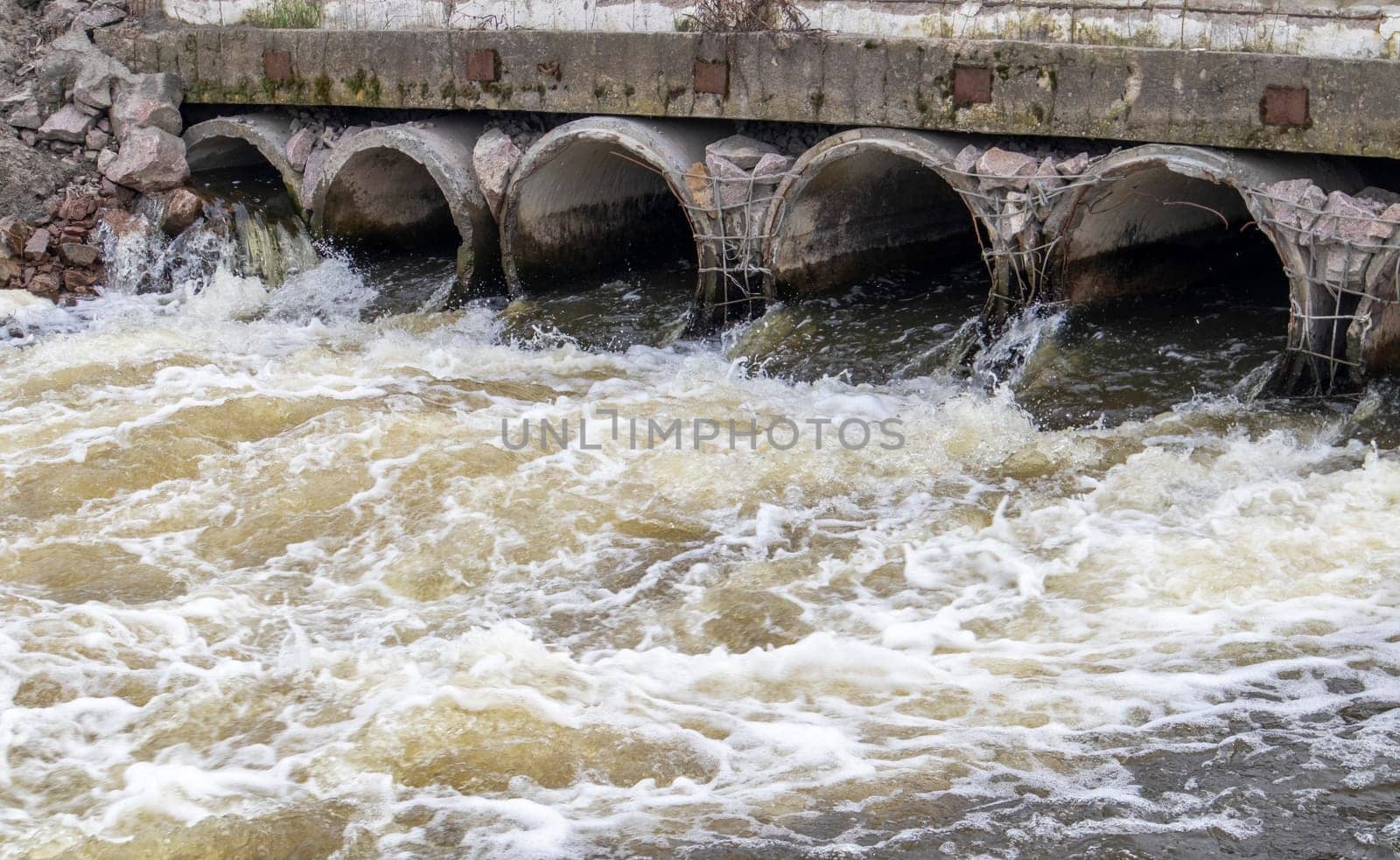 Environmental pollution, environmental disaster. Discharge of polluted sewage into the river from factory concrete pipes. Hazardous waste water. Environmental protection. Water pollution