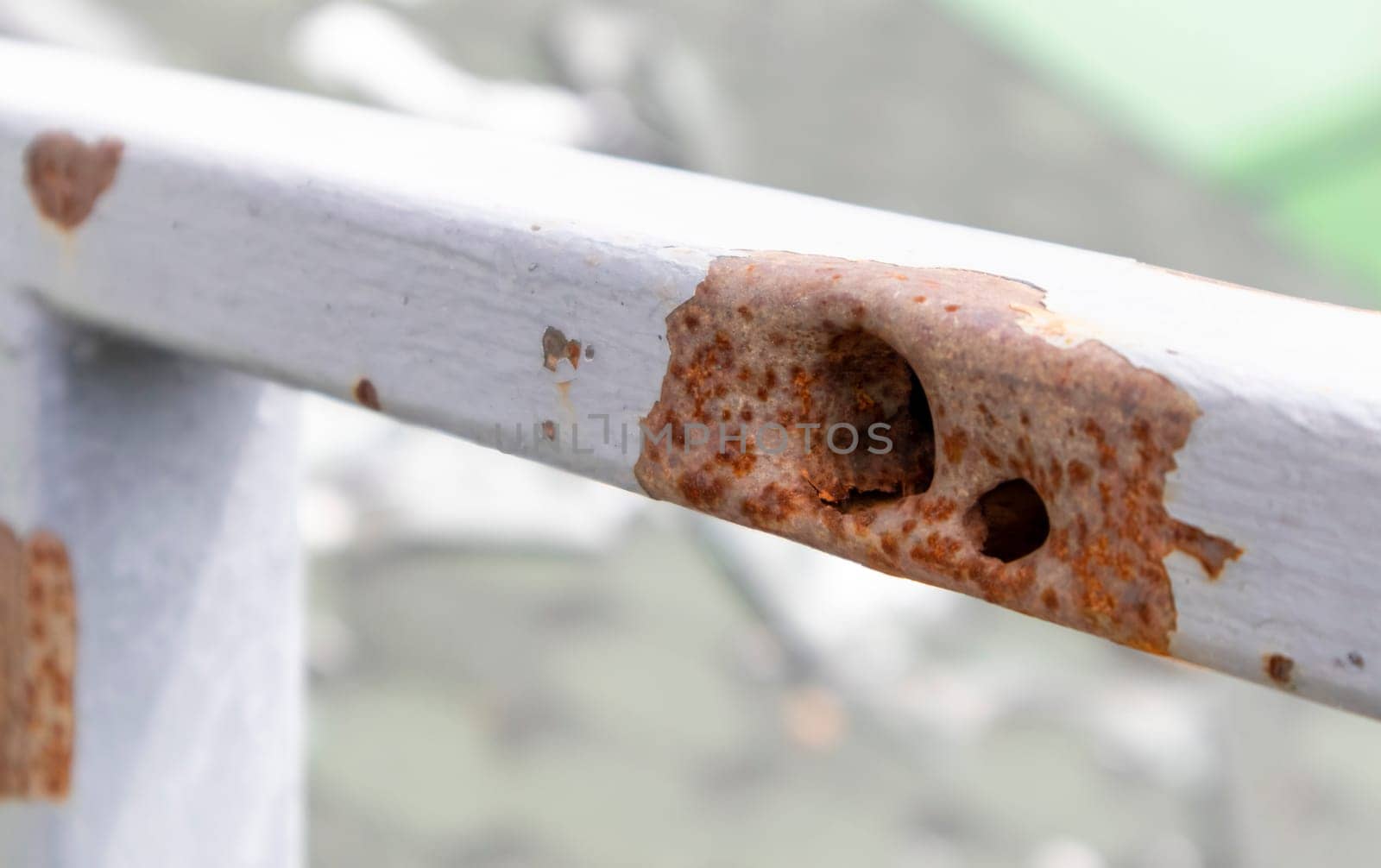 Bullet hole in the pipe. War in Ukraine. A hole from a shell fragment. Consequences of the war. Holes from shots on a metal pipe