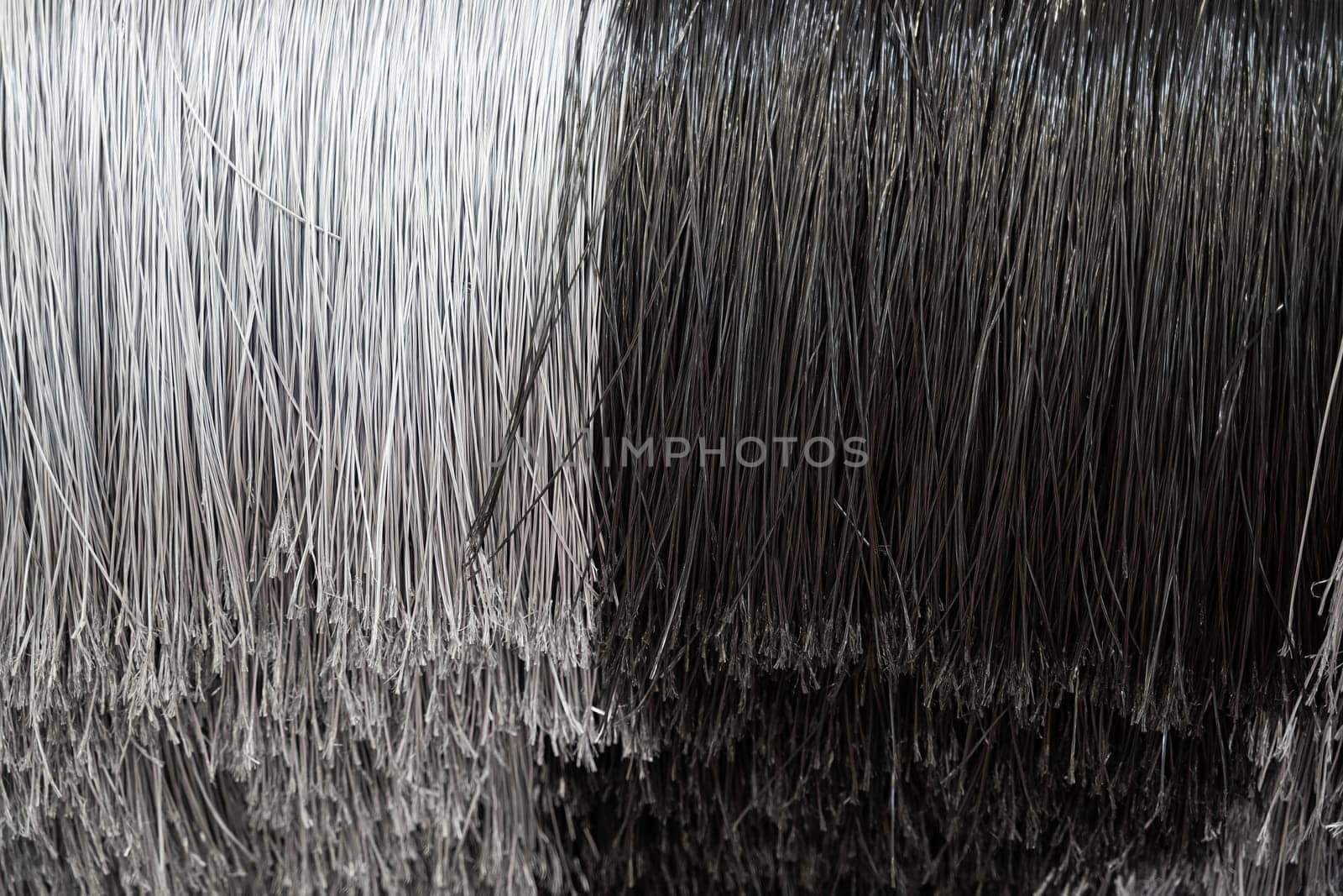 detail of black and white automatic car wash system cleaning fiber polyethylene sponge brushes on spinning rotor
