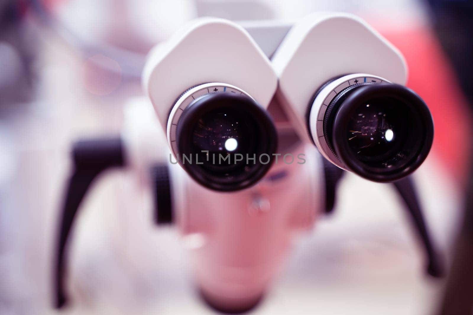 extreme closeup of medical microscope ocular black lenses with magnifying dials no people and shallow depth of field