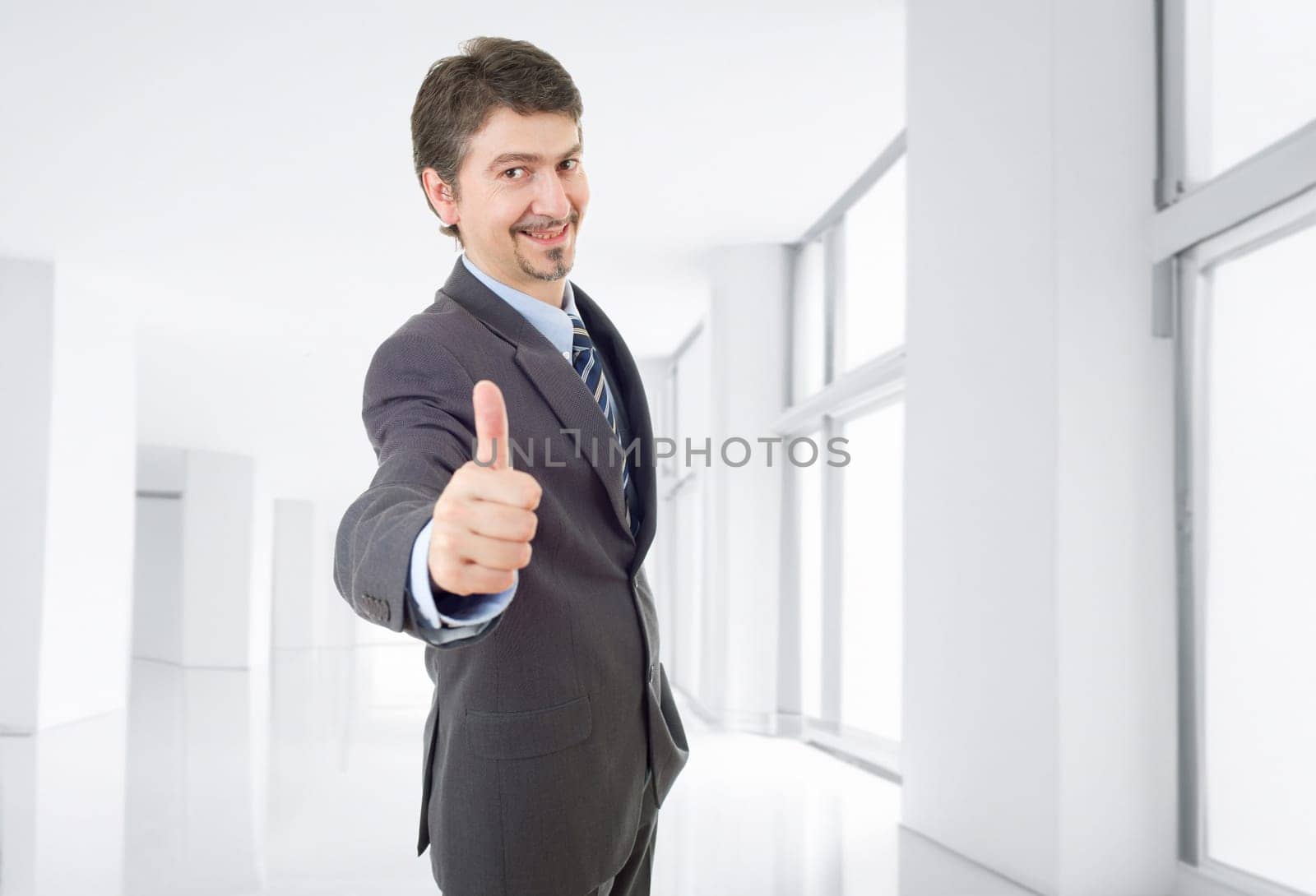 young business man going thumb up, at the office