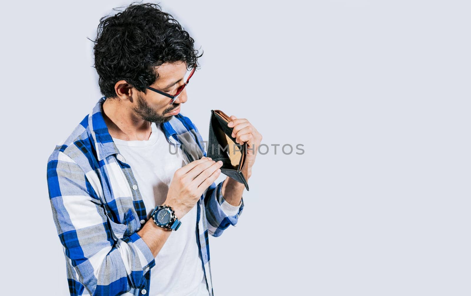 Man with financial problems showing empty wallet. Moneyless frustrated person concept. Sad man shaking an empty wallet, Sad person showing an empty wallet