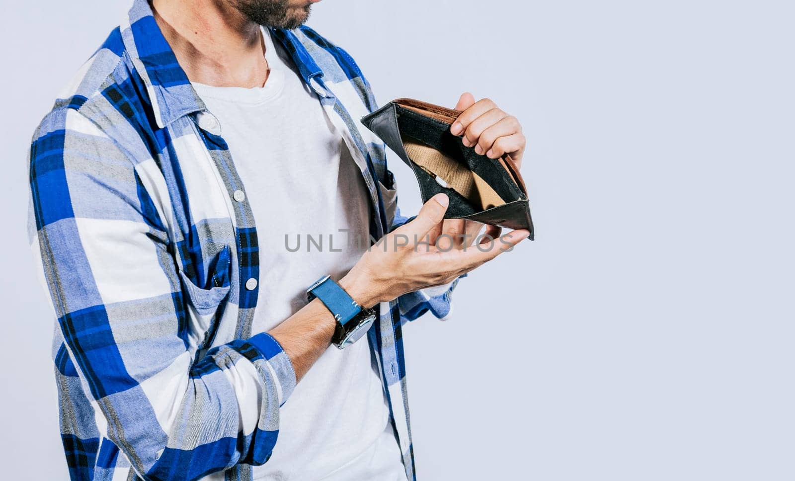 Moneyless frustrated person concept. Sad man showing an empty wallet, Sad person showing an empty wallet, Man with financial problems showing empty wallet