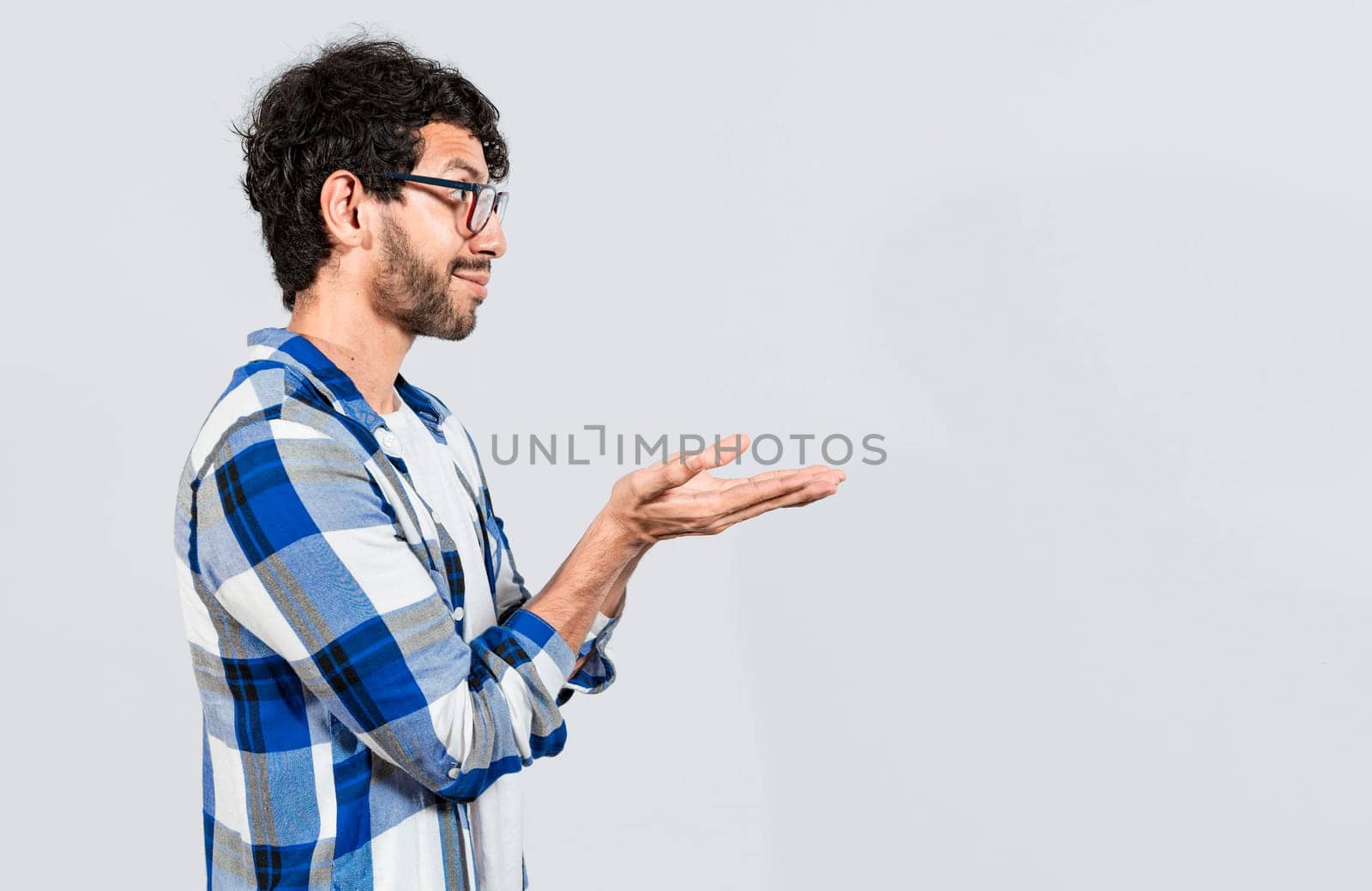 Smiling person recommending a product with his hands, Man recommending an advertisement with the palm of his hands. Guy recommending an ad space isolated