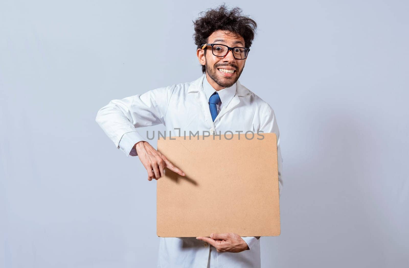 Professor in white coat holding a blank clipboard isolated. A scientist in a white coat is holding a blank clipboard. Scientist showing and pointing at a blank clipboard