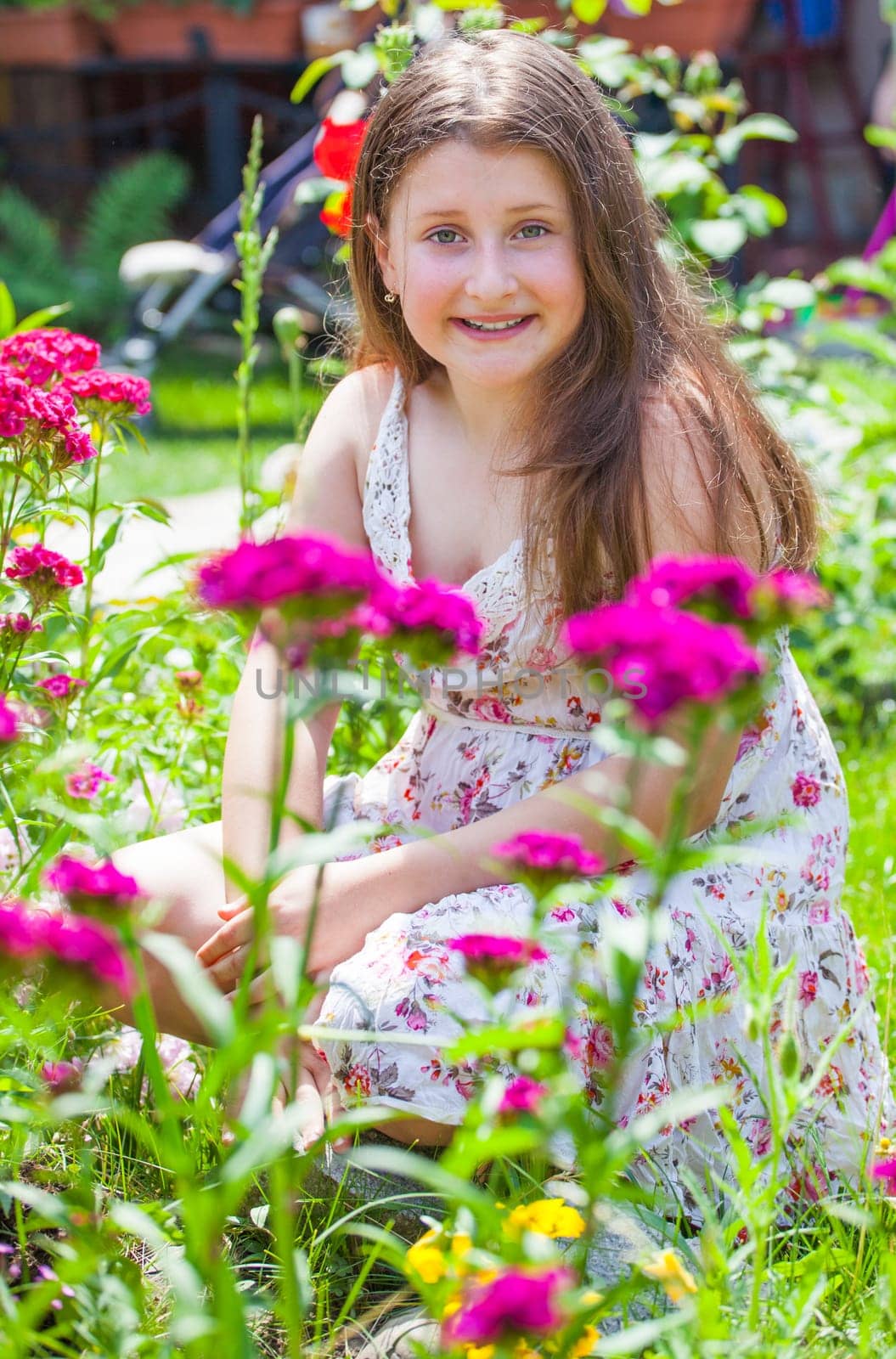 Portrait of a 10 year old girl enjoying the flower garden at home.