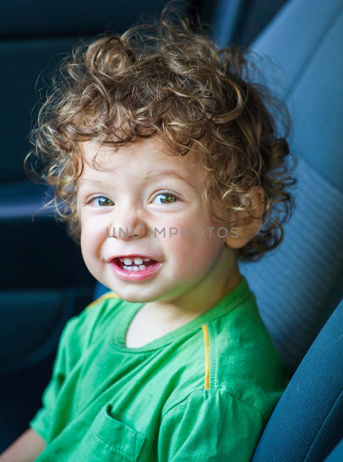 Portrait of 1 year old baby boy in the car.