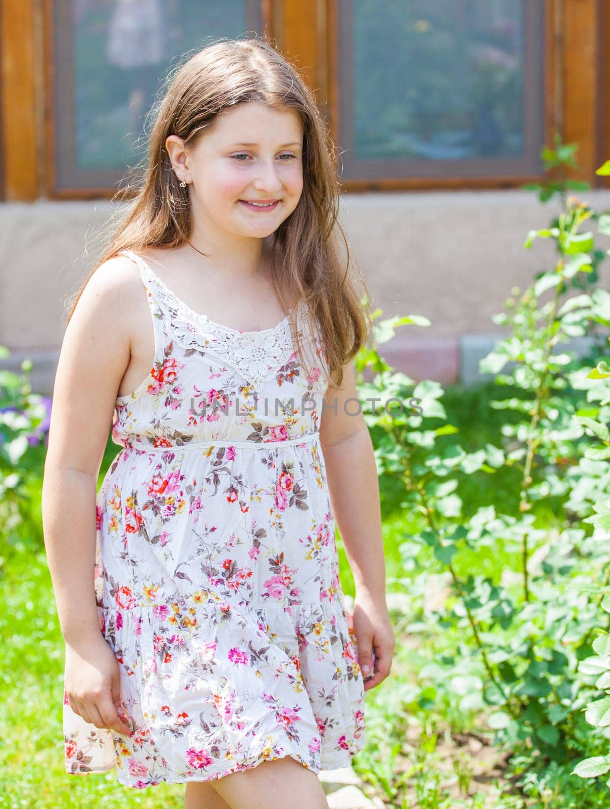 Portrait of a 10 year old girl enjoying the flower garden at home.