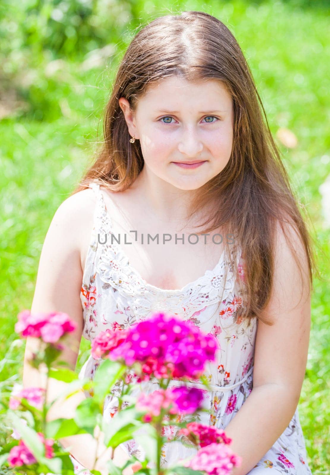 Portrait of a 10 year old girl enjoying the flower garden at home.