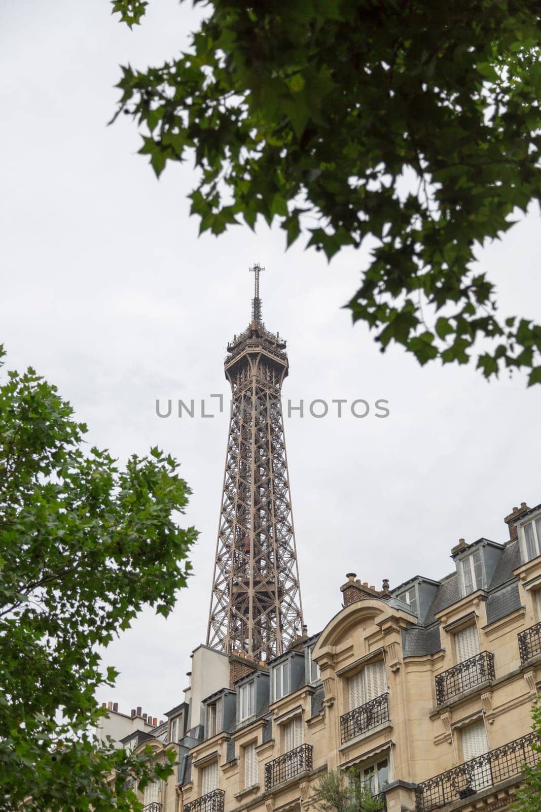 Eiffel Tower in Paris, France behind residential building.