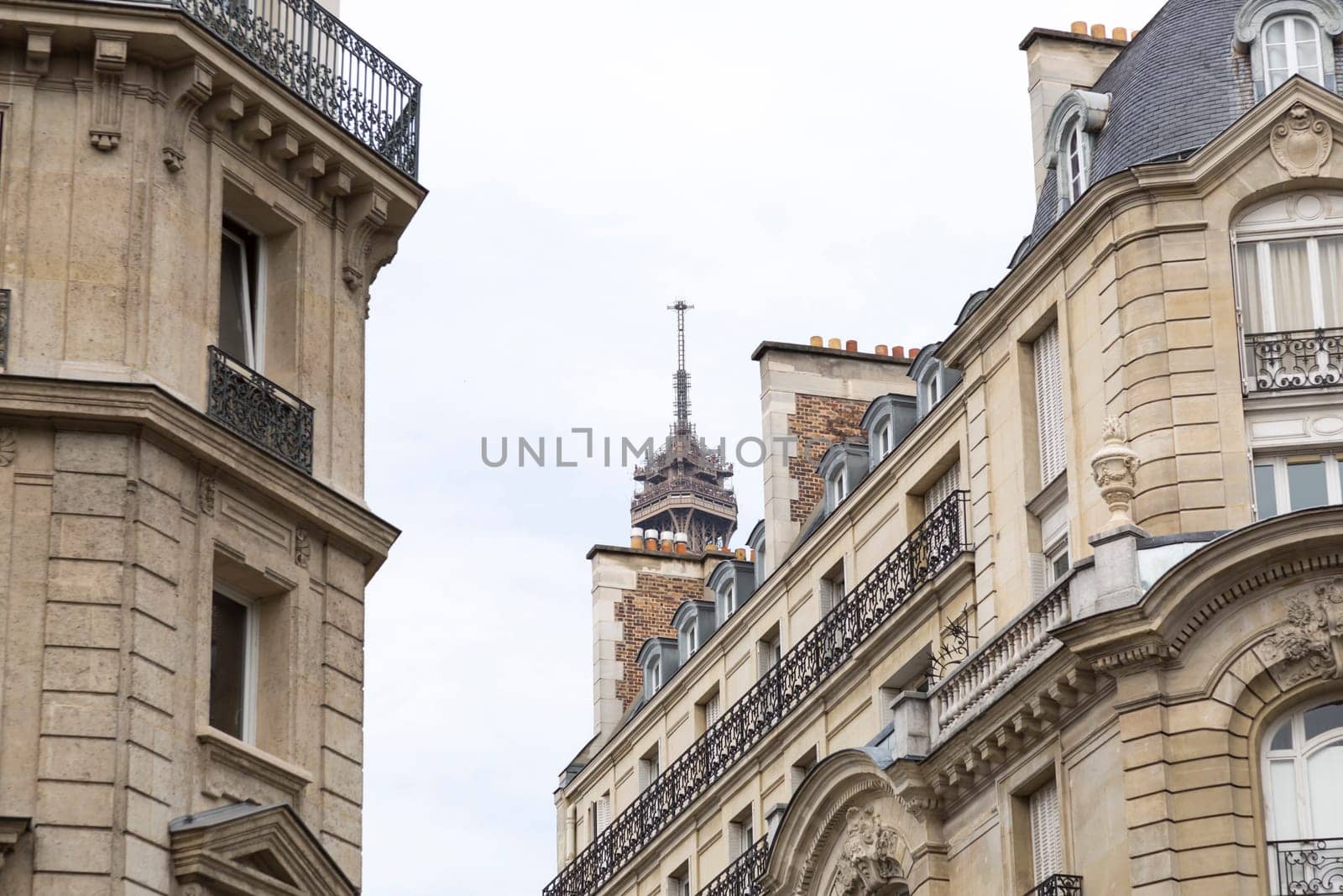 The Tip of the Eiffel Tower Hidden behind buildings.